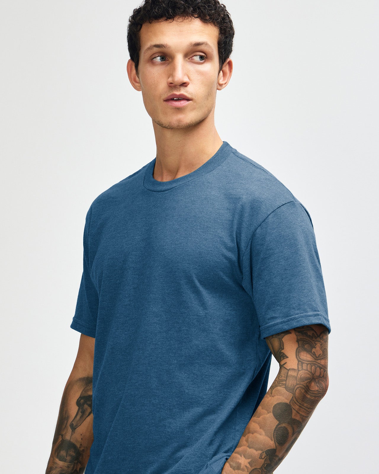 Male model wearing heather sea blue colour CVC Unisex Short Sleeve Crew Neck Tee (front pose) -heather sea blue