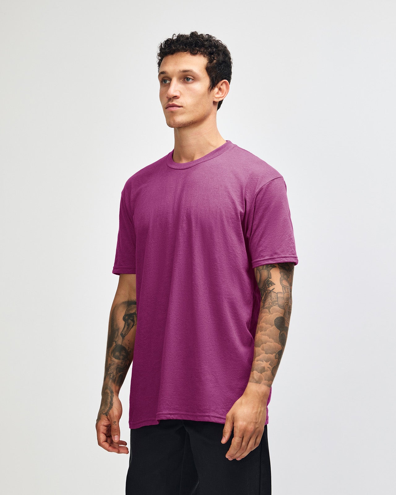 Male model wearing super pink colour CVC Unisex Short Sleeve Crew Neck Tee (front pose) -super pink