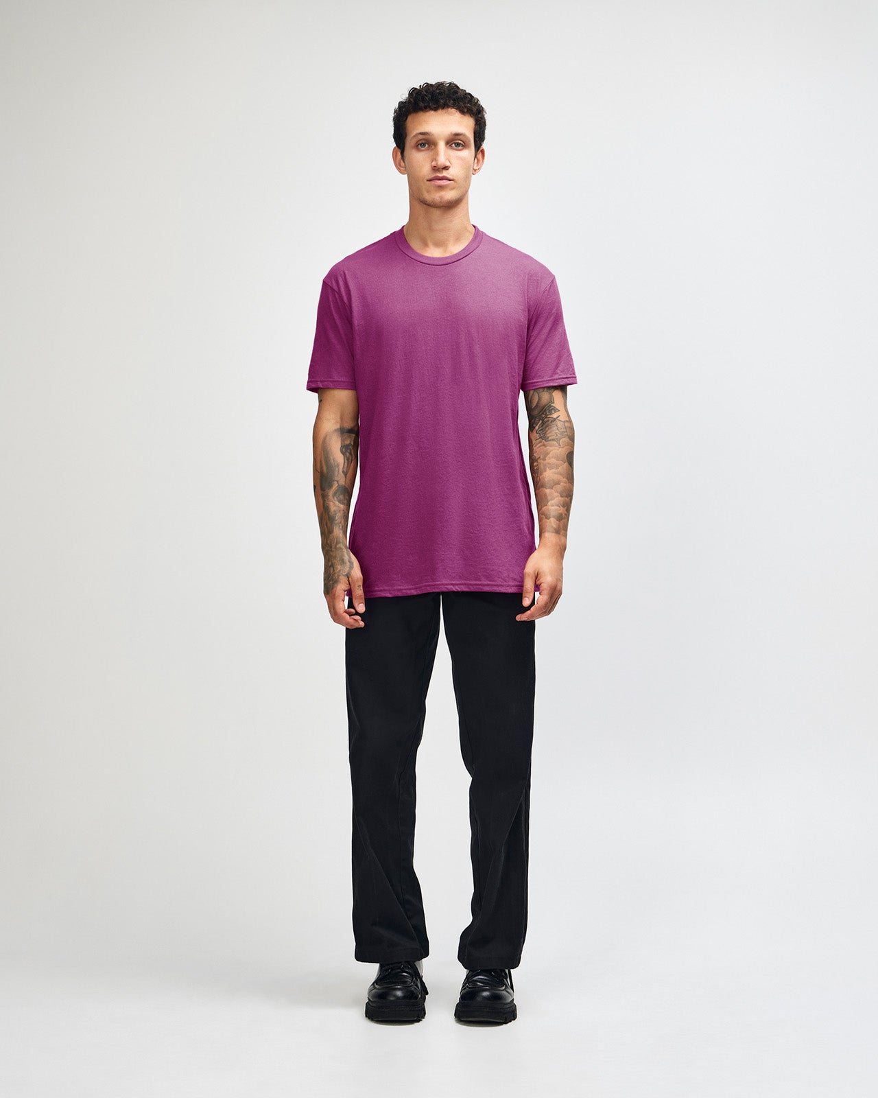 Male model wearing super pink colour CVC Unisex Short Sleeve Crew Neck Tee (front pose) -super pink