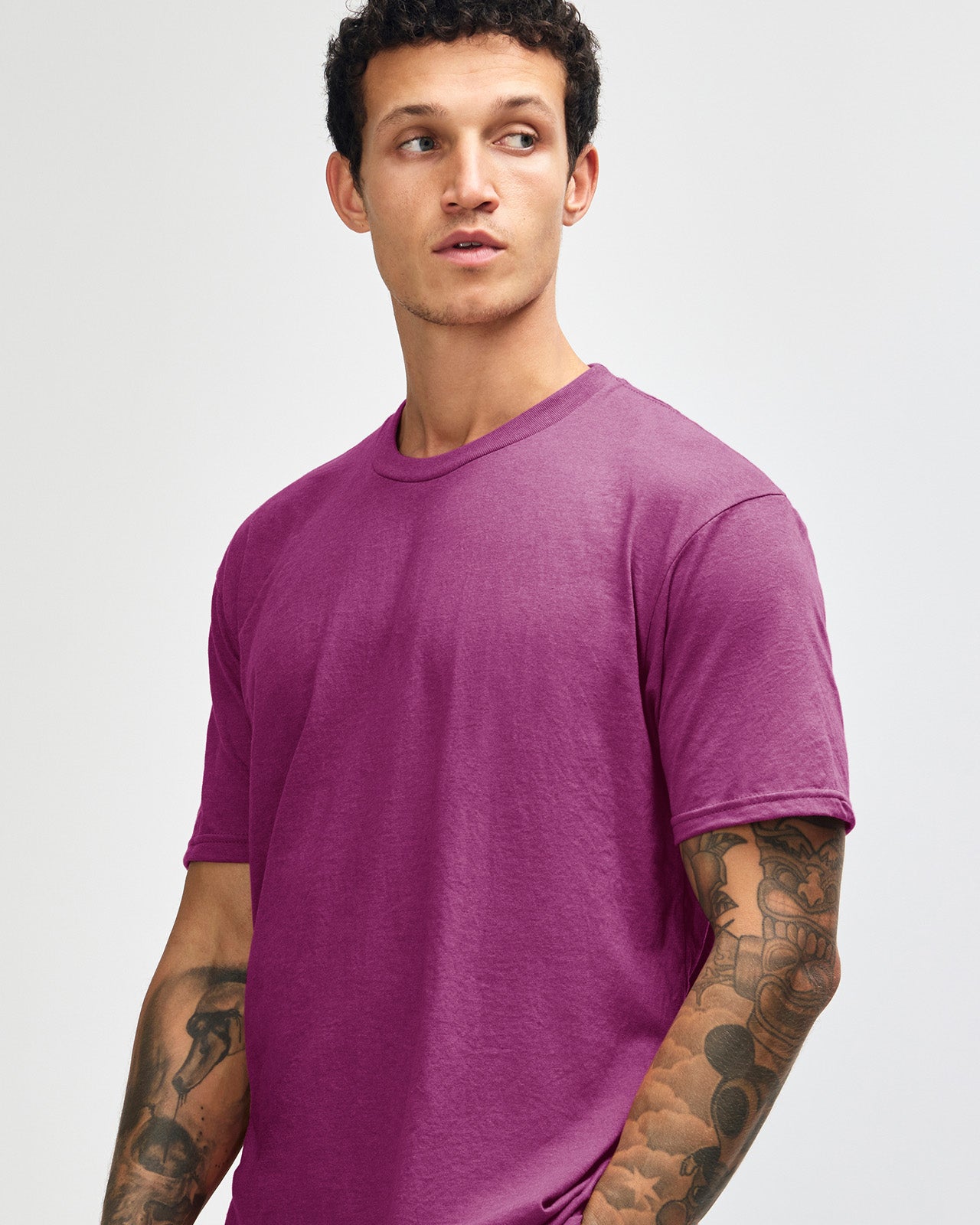 Male model wearing super pink colour CVC Unisex Short Sleeve Crew Neck Tee (front pose) -super pink
