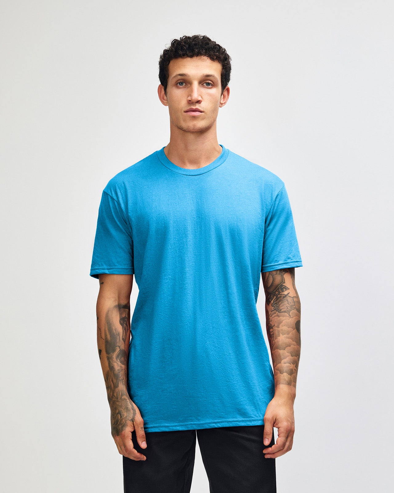 Male model wearing heather teal colour CVC Unisex Short Sleeve Crew Neck Tee (front pose) -heather teal