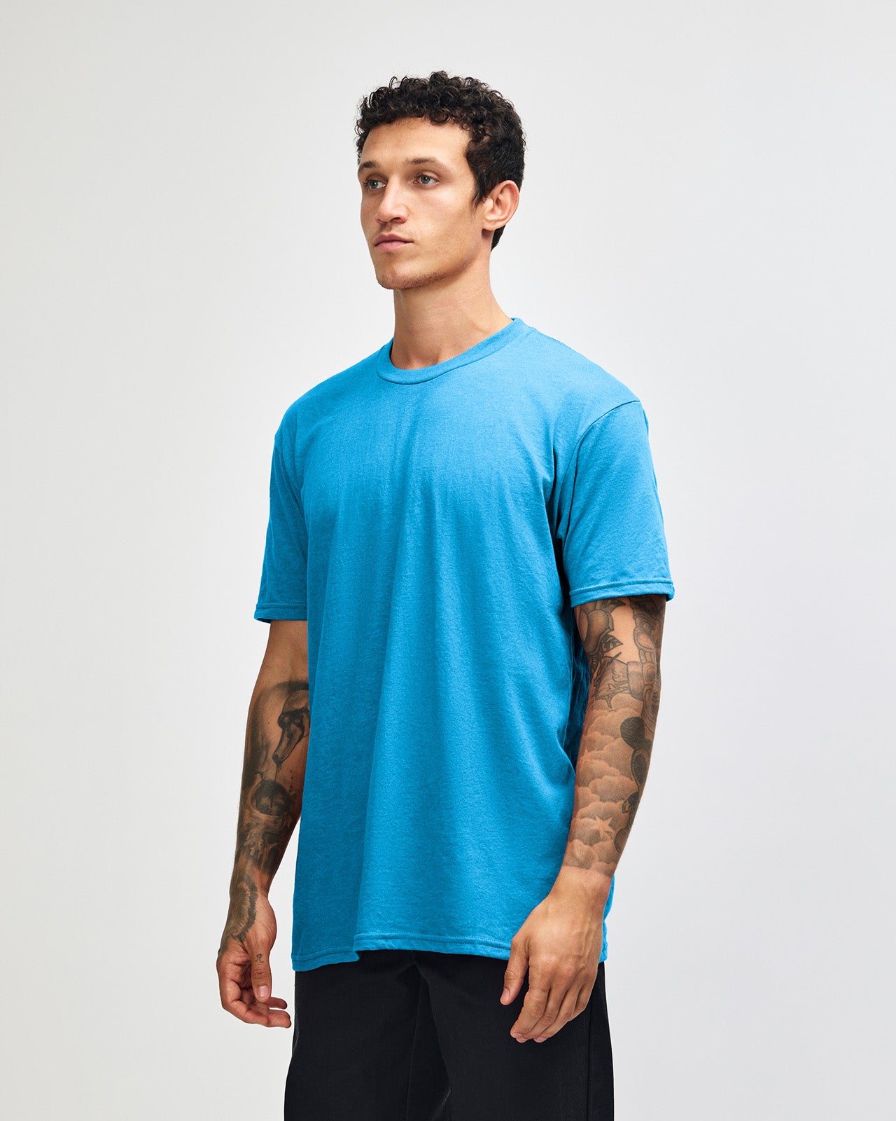 Male model wearing heather teal colour CVC Unisex Short Sleeve Crew Neck Tee (front pose) -heather teal