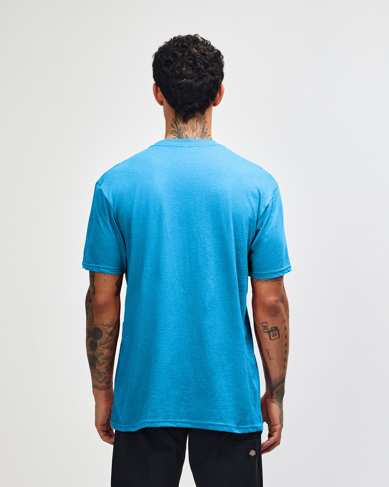 Male model wearing heather teal colour CVC Unisex Short Sleeve Crew Neck Tee (back pose) -heather teal
