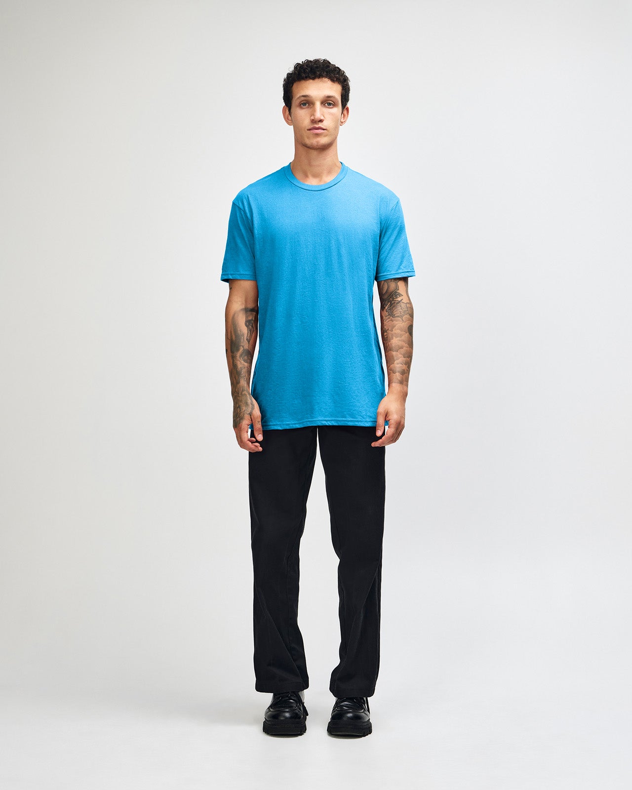 Male model wearing heather teal colour CVC Unisex Short Sleeve Crew Neck Tee (front pose) -heather teal