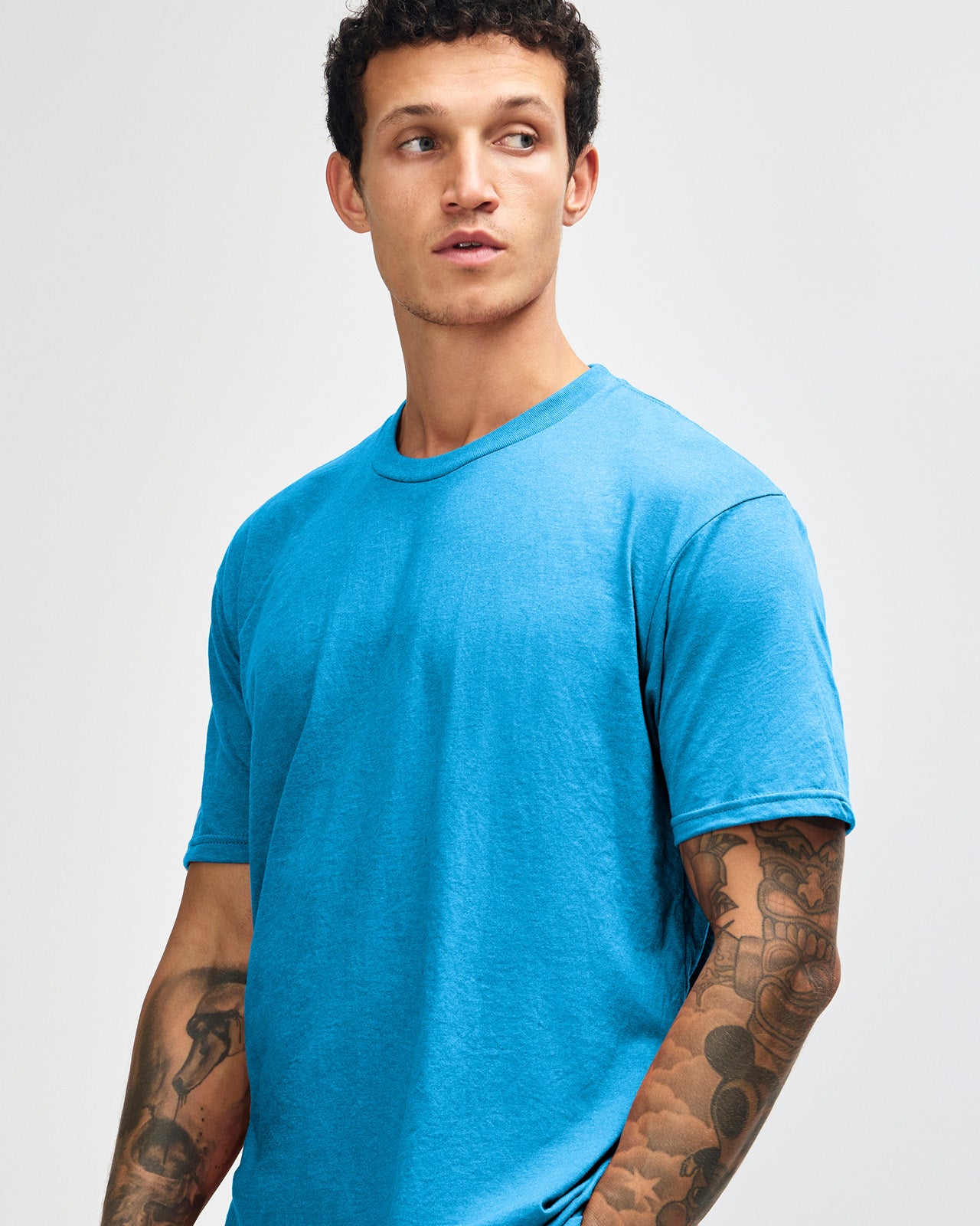 Male model wearing heather teal colour CVC Unisex Short Sleeve Crew Neck Tee (front pose) -heather teal