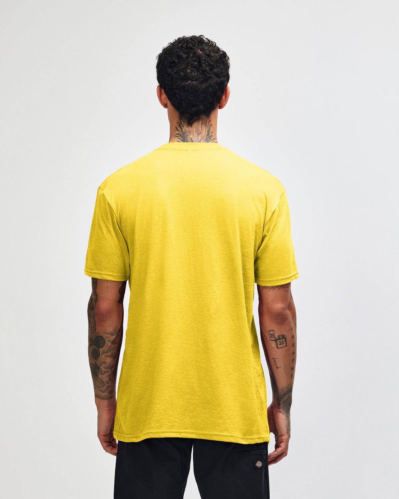 Male model wearing heather yellow colour CVC Unisex Short Sleeve Crew Neck Tee (back pose) -heather yellow