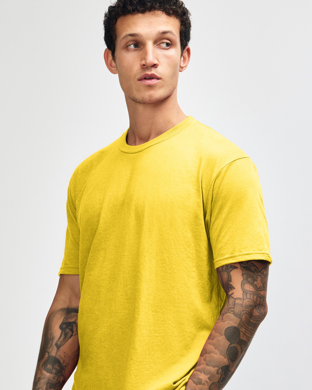 Male model wearing heather yellow colour CVC Unisex Short Sleeve Crew Neck Tee (front pose) -heather yellow