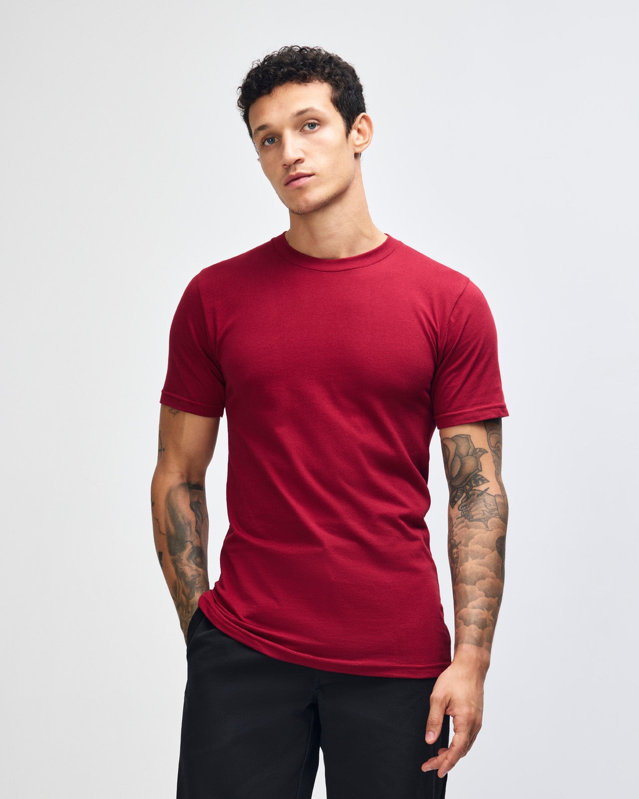 Male mode wearing cranberry colour American Apparel Unisex Short Sleeve Crew Neck Tee (Front pose) -cranberry