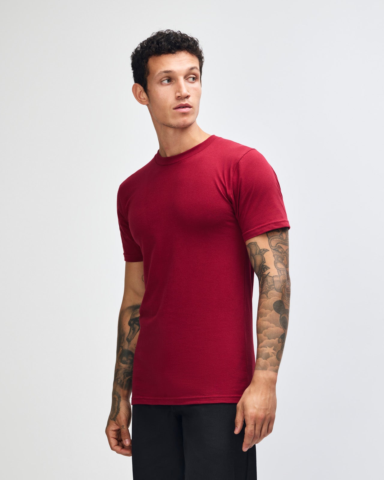 Male mode wearing cranberry colour American Apparel Unisex Short Sleeve Crew Neck Tee (Front pose) -cranberry