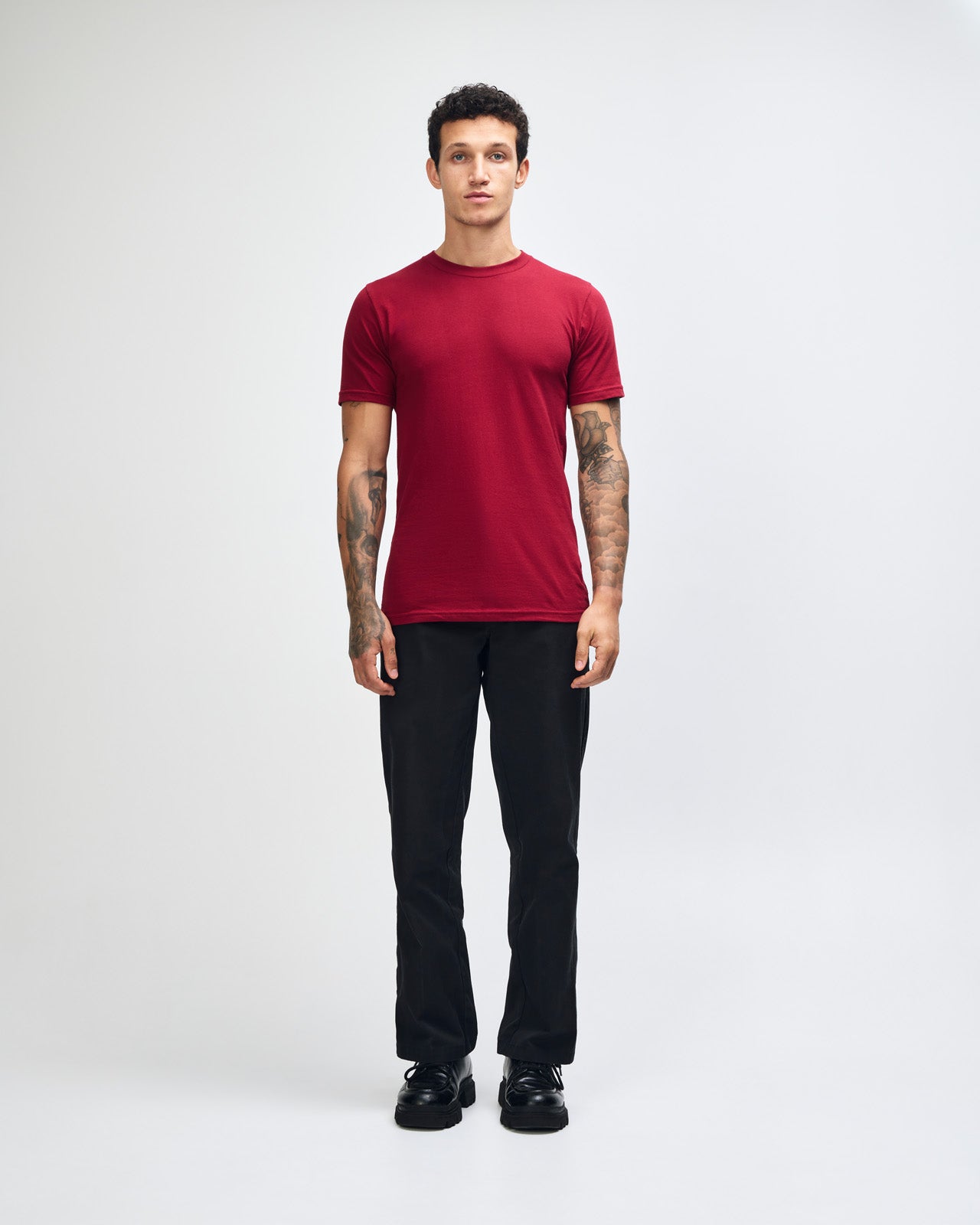 Male mode wearing cranberry colour American Apparel Unisex Short Sleeve Crew Neck Tee (Front pose) -cranberry