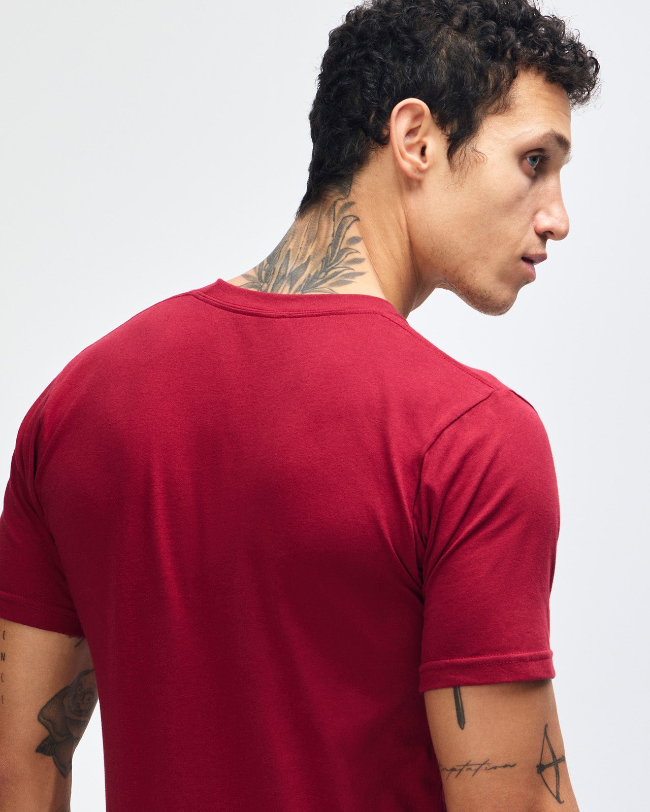 Male mode wearing cranberry colour American Apparel Unisex Short Sleeve Crew Neck Tee (back pose) -cranberry