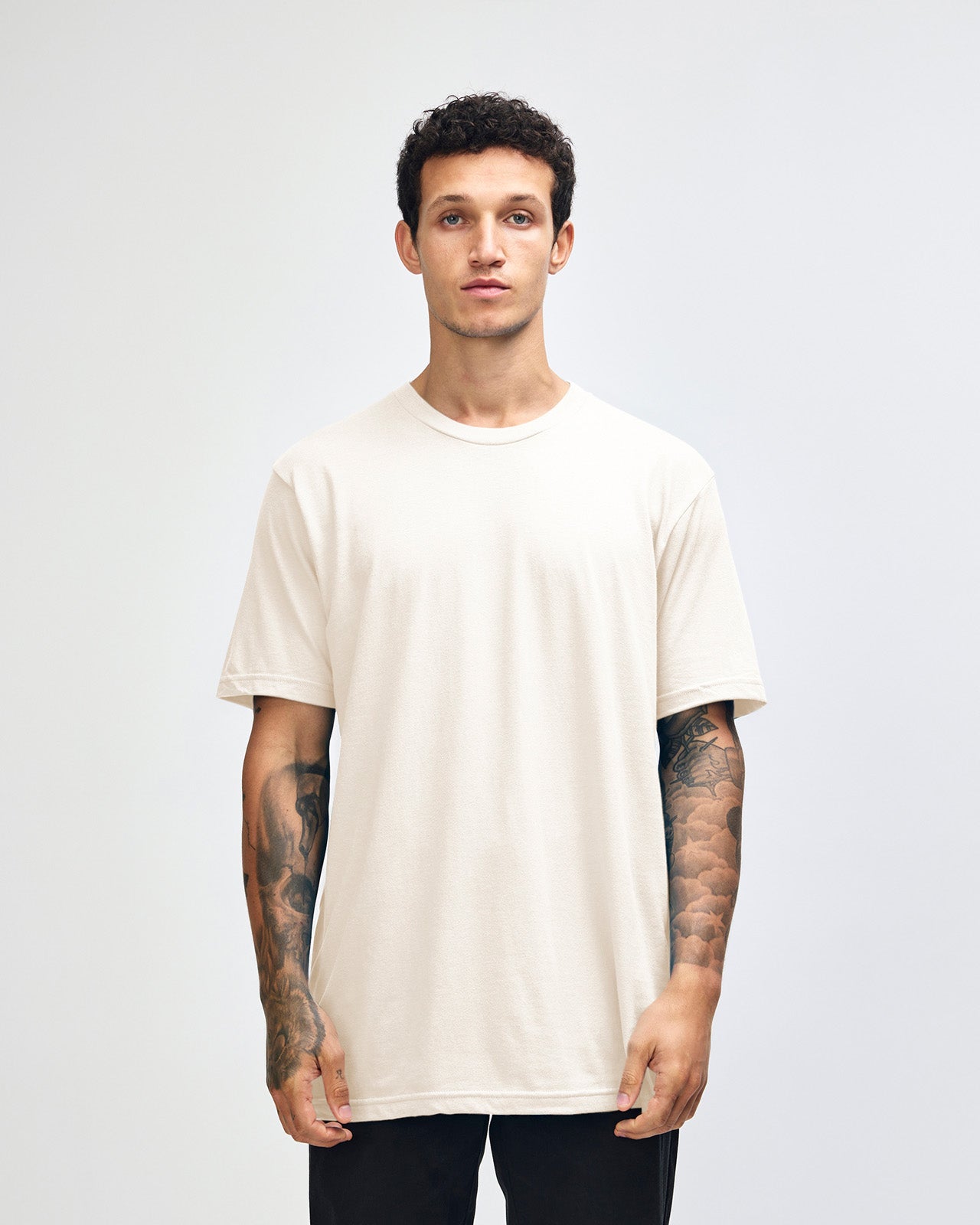Male mode wearing cream colour American Apparel Fine jersey Unisex Short Sleeve Crew Neck Tee (half Front pose) -cream 