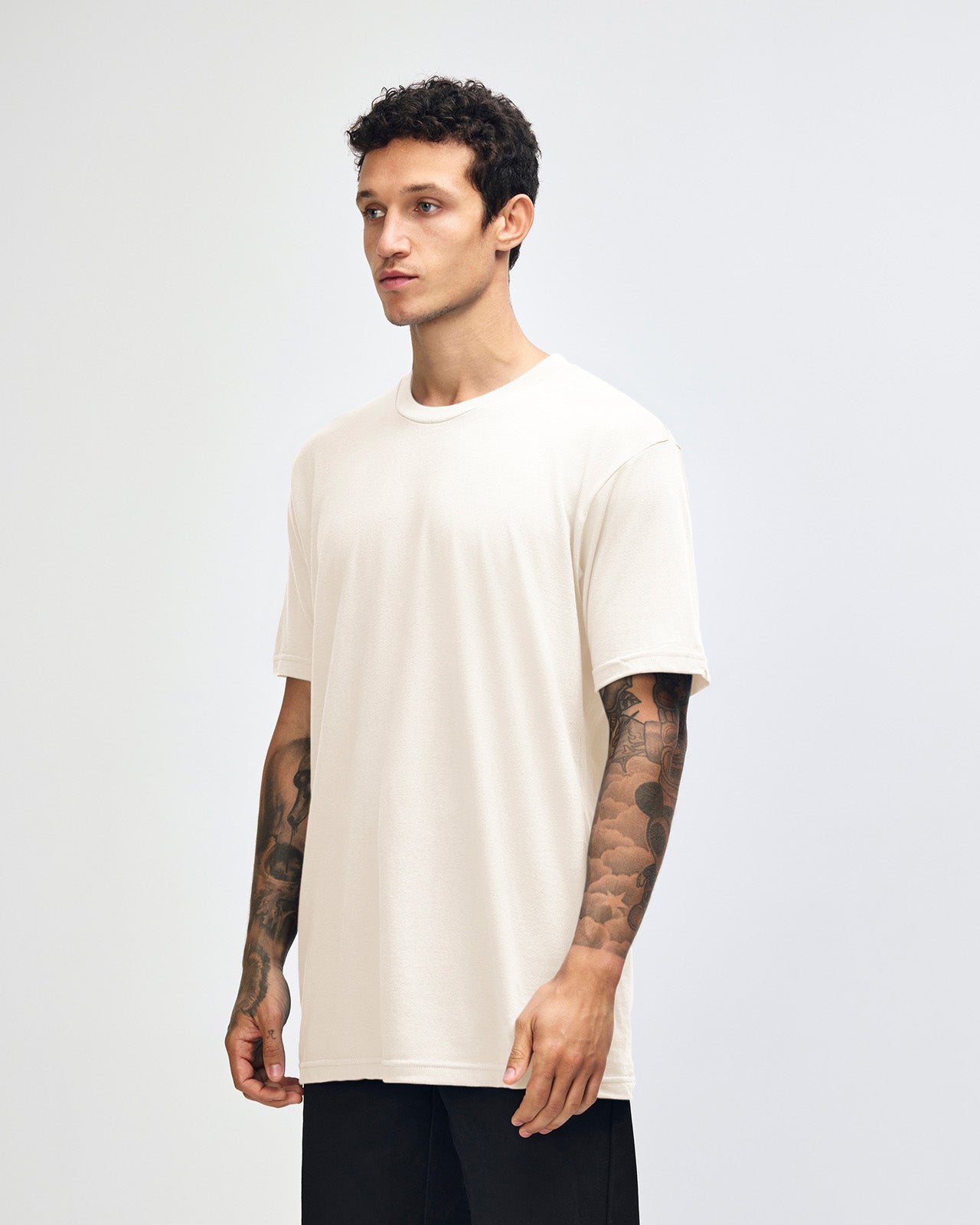 Male mode wearing cream colour American Apparel Fine jersey Unisex Short Sleeve Crew Neck Tee (half Front pose) -cream 