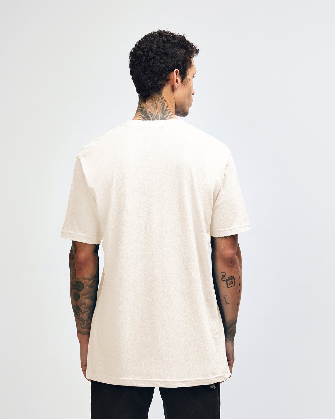 Male mode wearing cream colour American Apparel Fine jersey Unisex Short Sleeve Crew Neck Tee (half back pose) -cream 