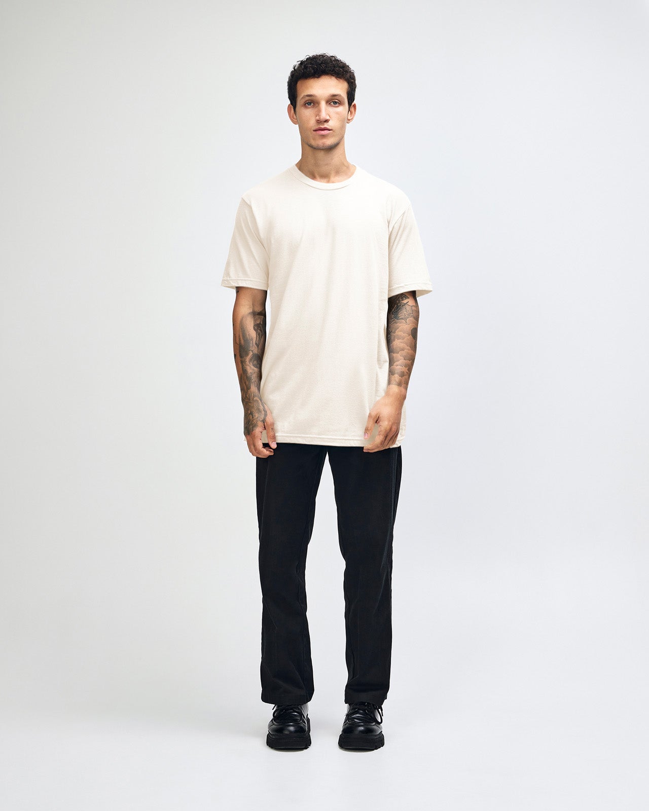 Male mode wearing cream colour American Apparel Fine jersey Unisex Short Sleeve Crew Neck Tee (Full Front pose) -cream 