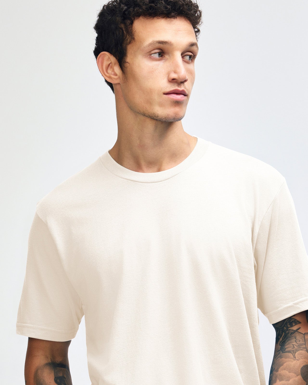 Male mode wearing cream colour American Apparel Fine jersey Unisex Short Sleeve Crew Neck Tee (half Front pose) -cream 