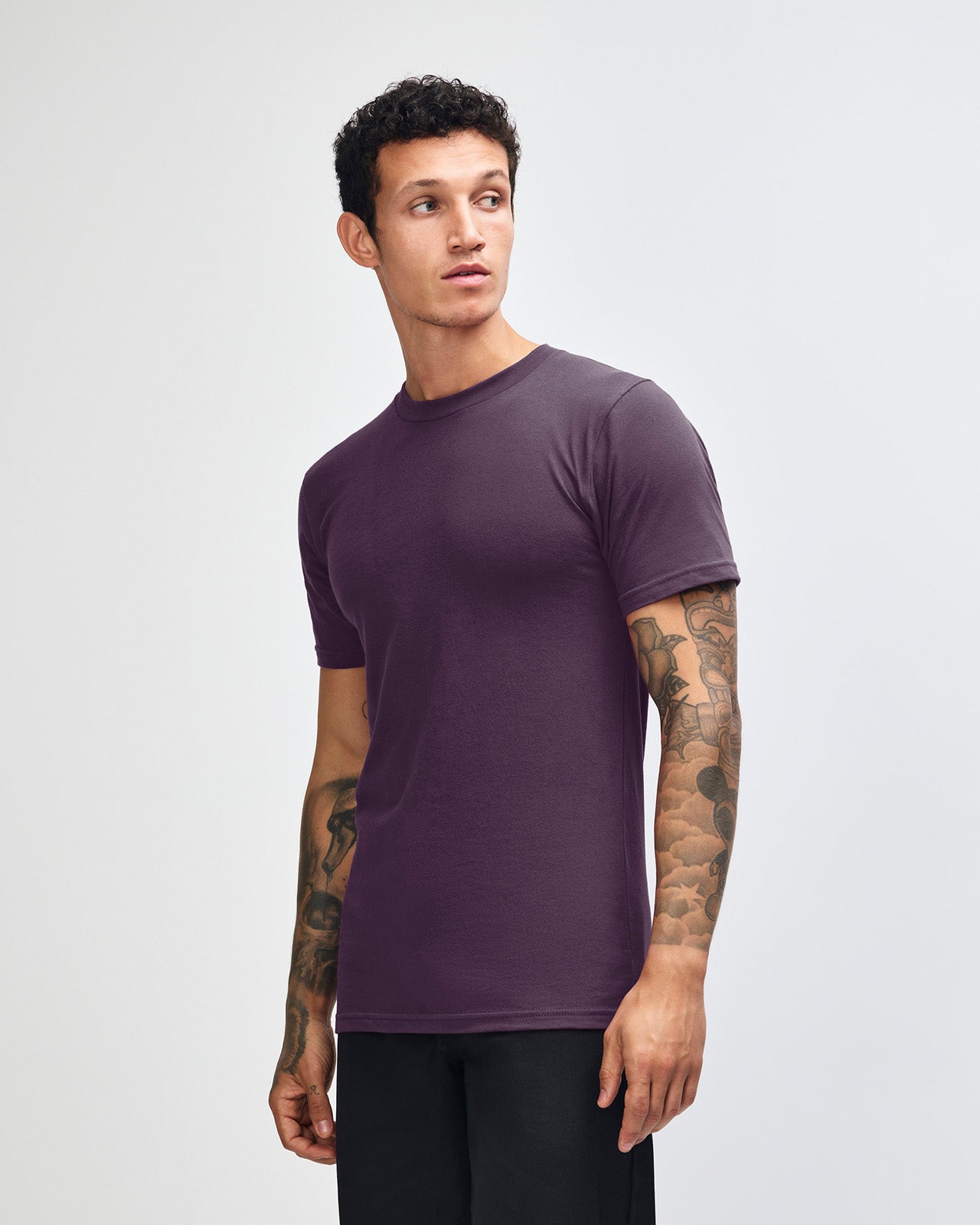 Male mode wearing eggplant colour American Apparel Fine jersey Unisex Short Sleeve Crew Neck Tee (Front pose) -eggplant