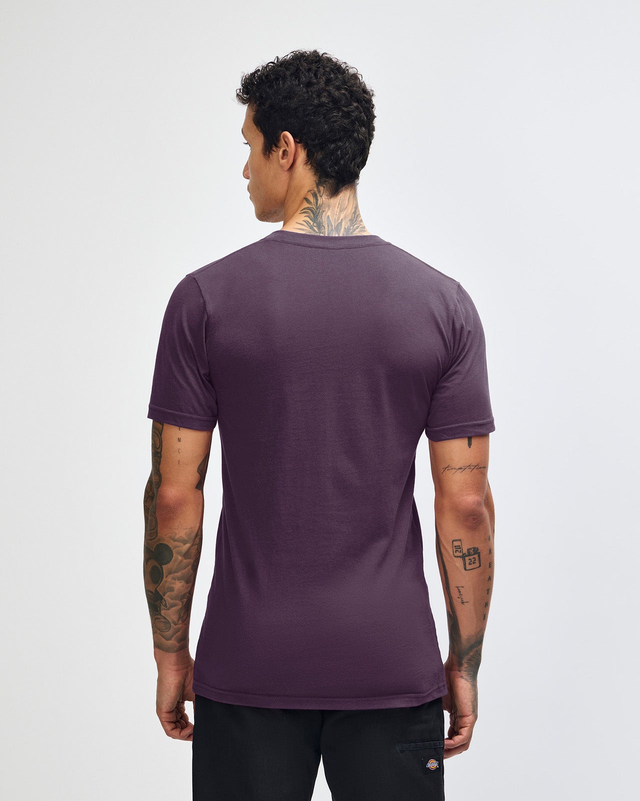 Male mode wearing eggplant colour American Apparel Fine jersey Unisex Short Sleeve Crew Neck Tee (back pose) -eggplant