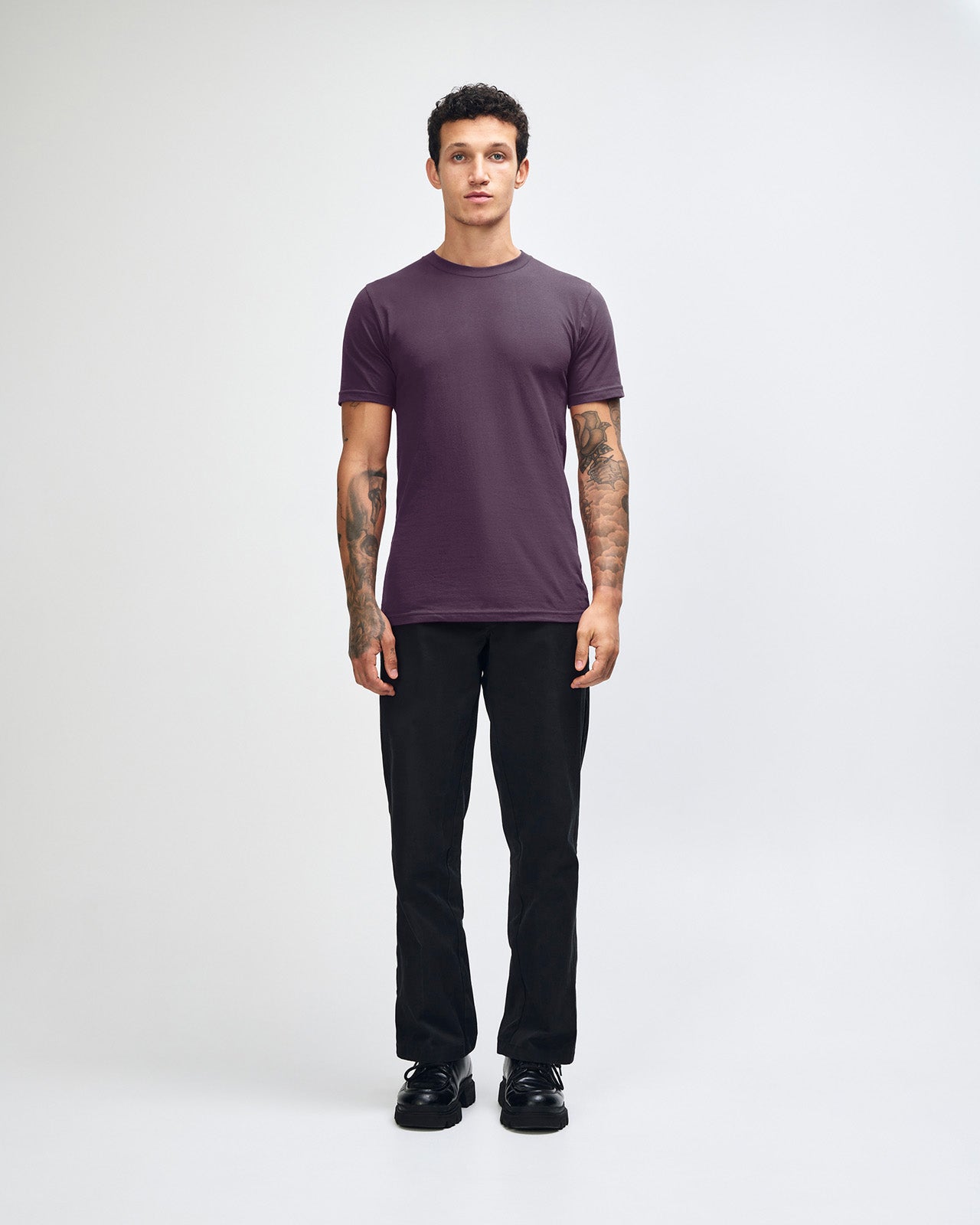 Male mode wearing eggplant colour American Apparel Fine jersey Unisex Short Sleeve Crew Neck Tee (Front pose) -eggplant