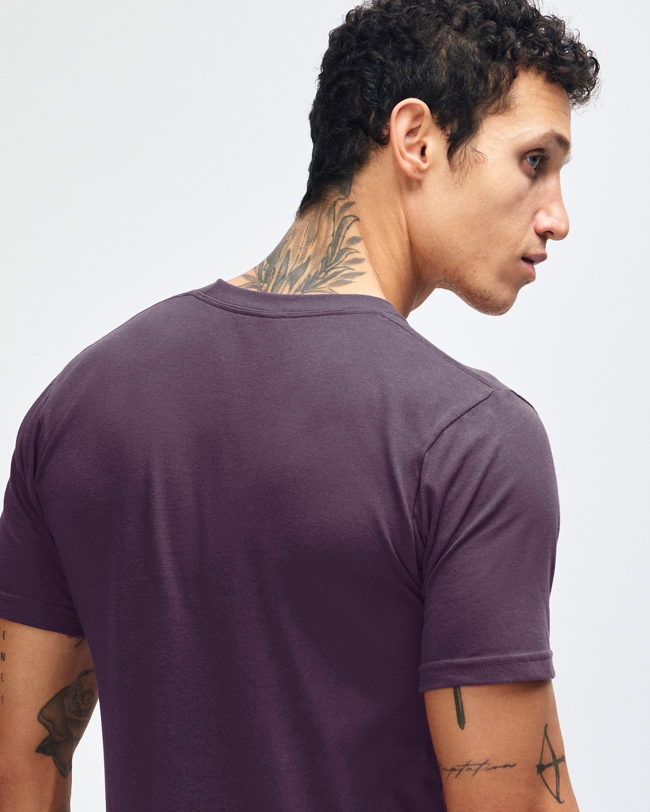 Male mode wearing eggplant colour American Apparel Fine jersey Unisex Short Sleeve Crew Neck Tee (back pose) -eggplant