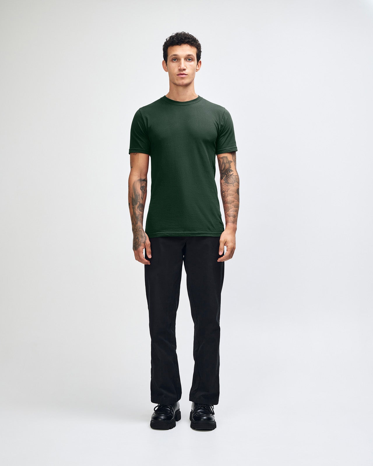 Male mode wearing forest colour American Apparel Fine jersey Unisex Short Sleeve Crew Neck Tee (Front pose) -forest 