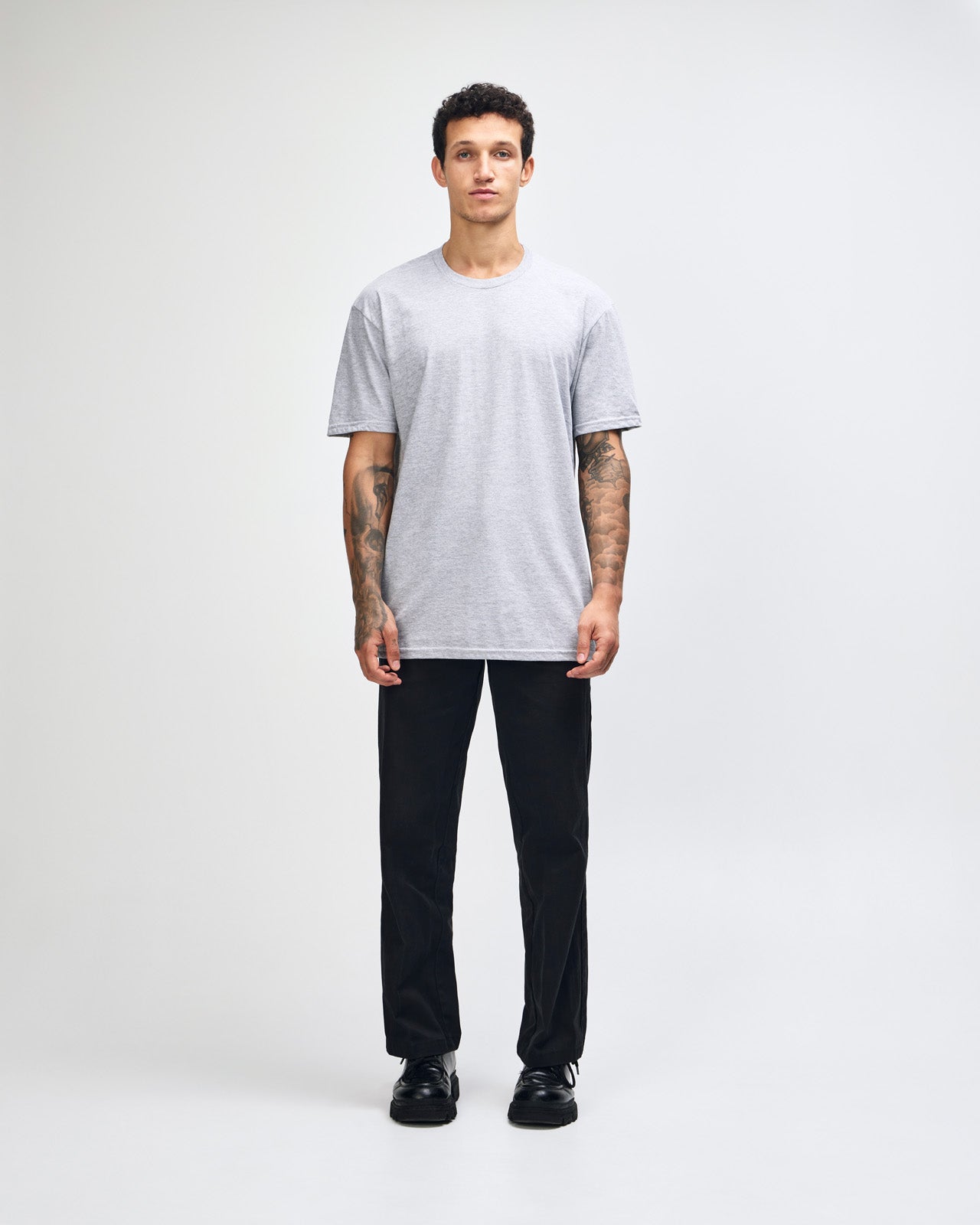 male model wearing heather grey colour Fine Jersey Unisex Crew Neck Tee (front pose) -heather grey