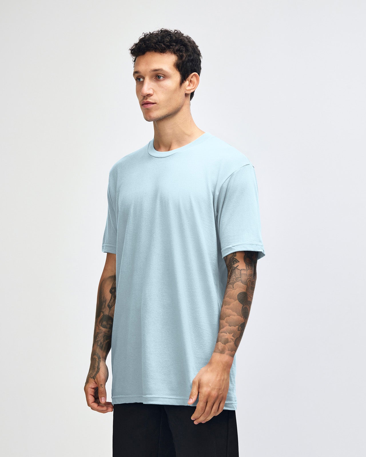 Male model wearing American Apparel Powder Blue Colour Fine Jersey Unisex Short Sleeve Crew Neck Tee (front pose) -powder blue 