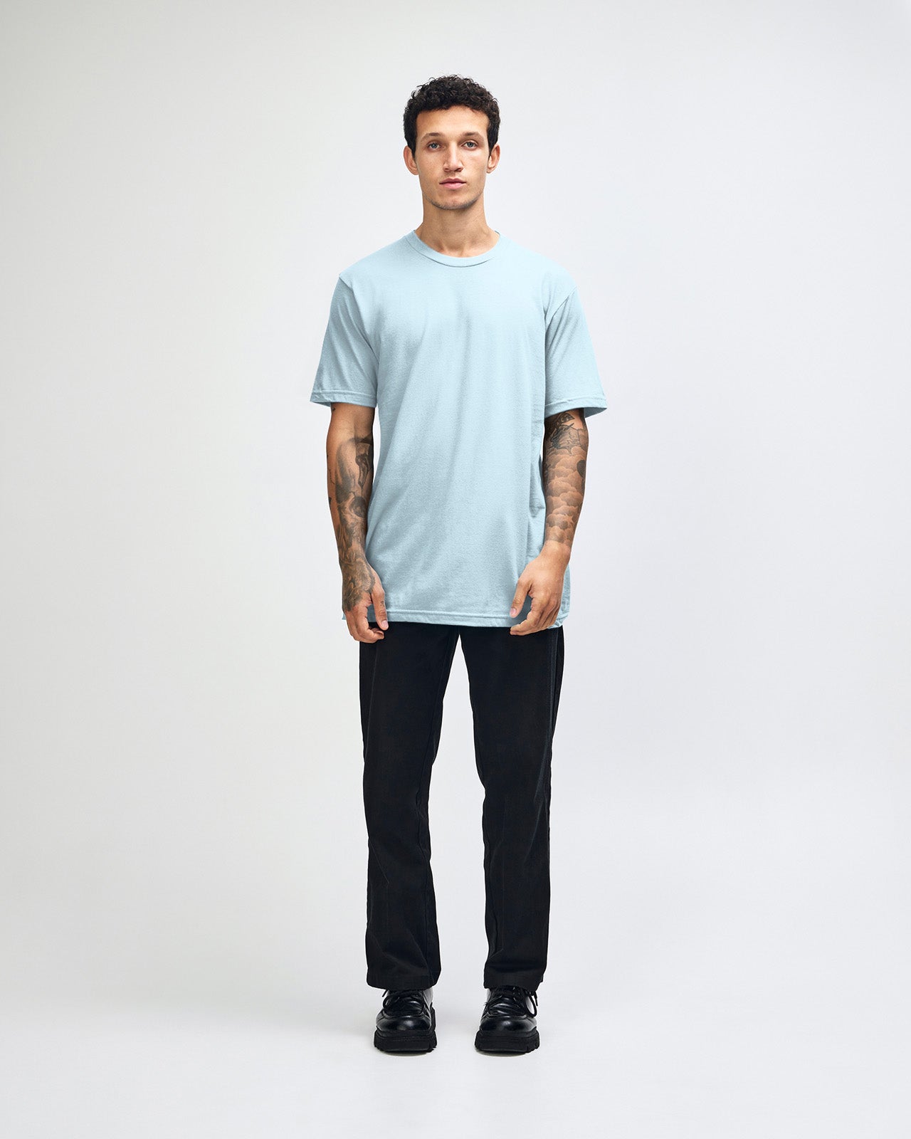 Male model wearing American Apparel Powder Blue Colour Fine Jersey Unisex Short Sleeve Crew Neck Tee (front pose) -powder blue 