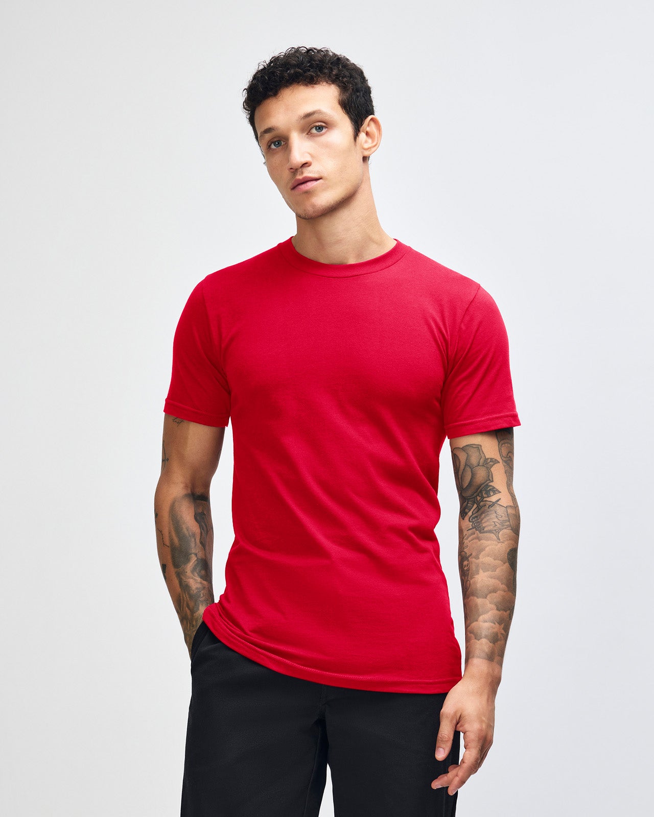 Male model wearing American Apparel Powder Red Colour Fine Jersey Unisex Short Sleeve Crew Neck Tee (front pose) -red