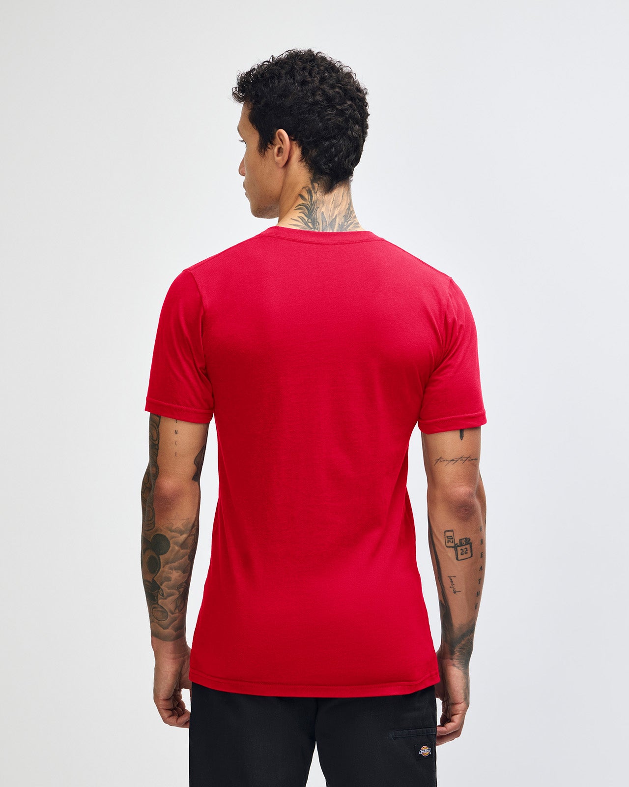 Male model wearing American Apparel Powder Red Colour Fine Jersey Unisex Short Sleeve Crew Neck Tee (back pose) -red