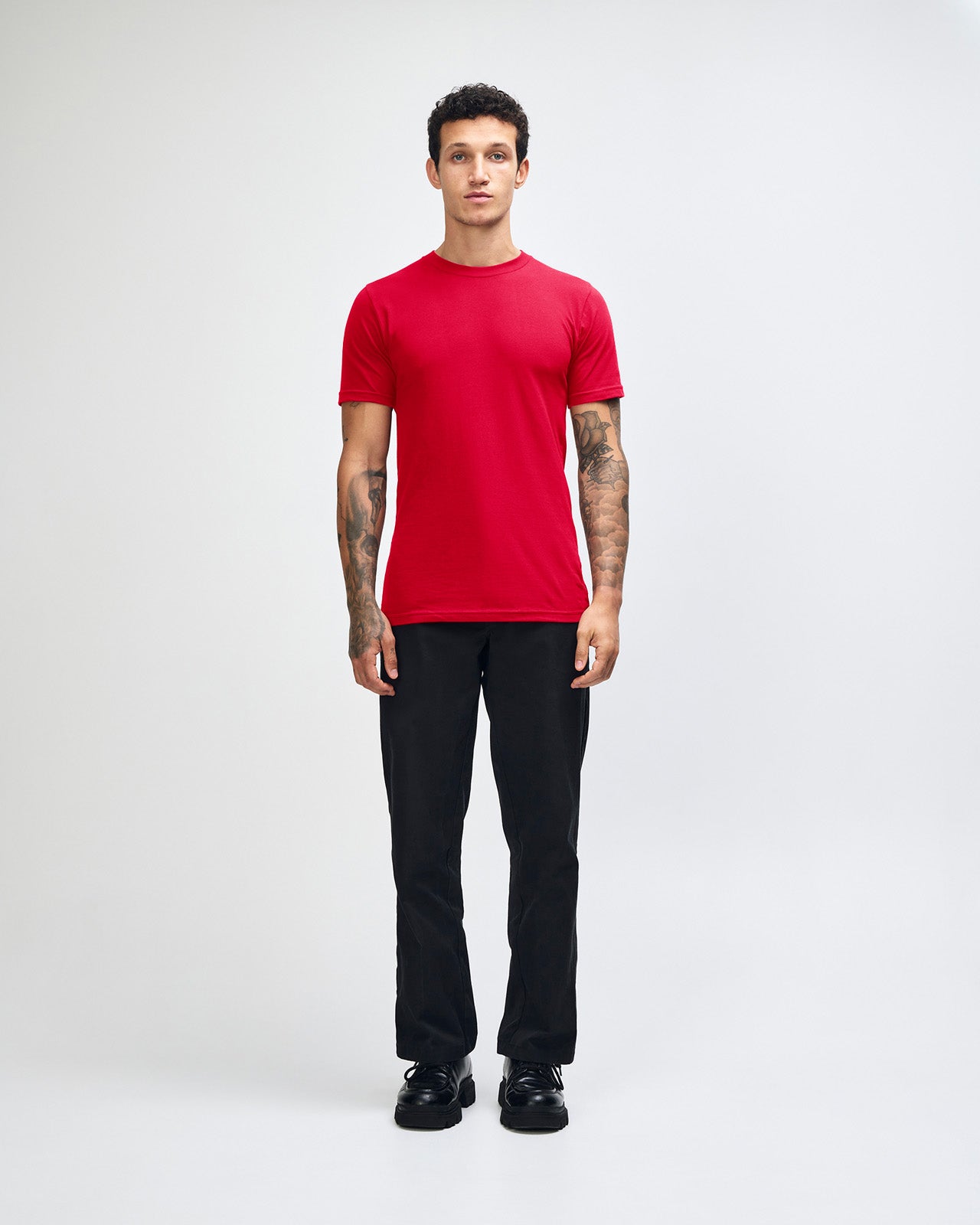 Male model wearing American Apparel Powder Red Colour Fine Jersey Unisex Short Sleeve Crew Neck Tee (front pose) -red