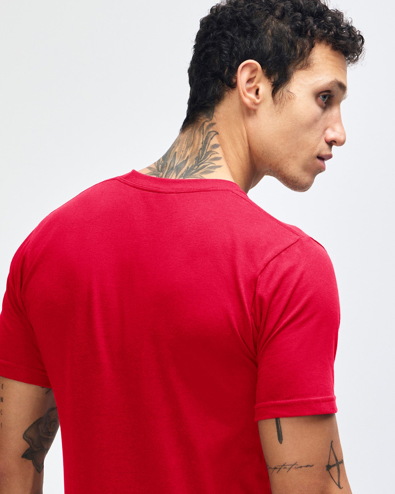 Male model wearing American Apparel Powder Red Colour Fine Jersey Unisex Short Sleeve Crew Neck Tee (back pose) -red