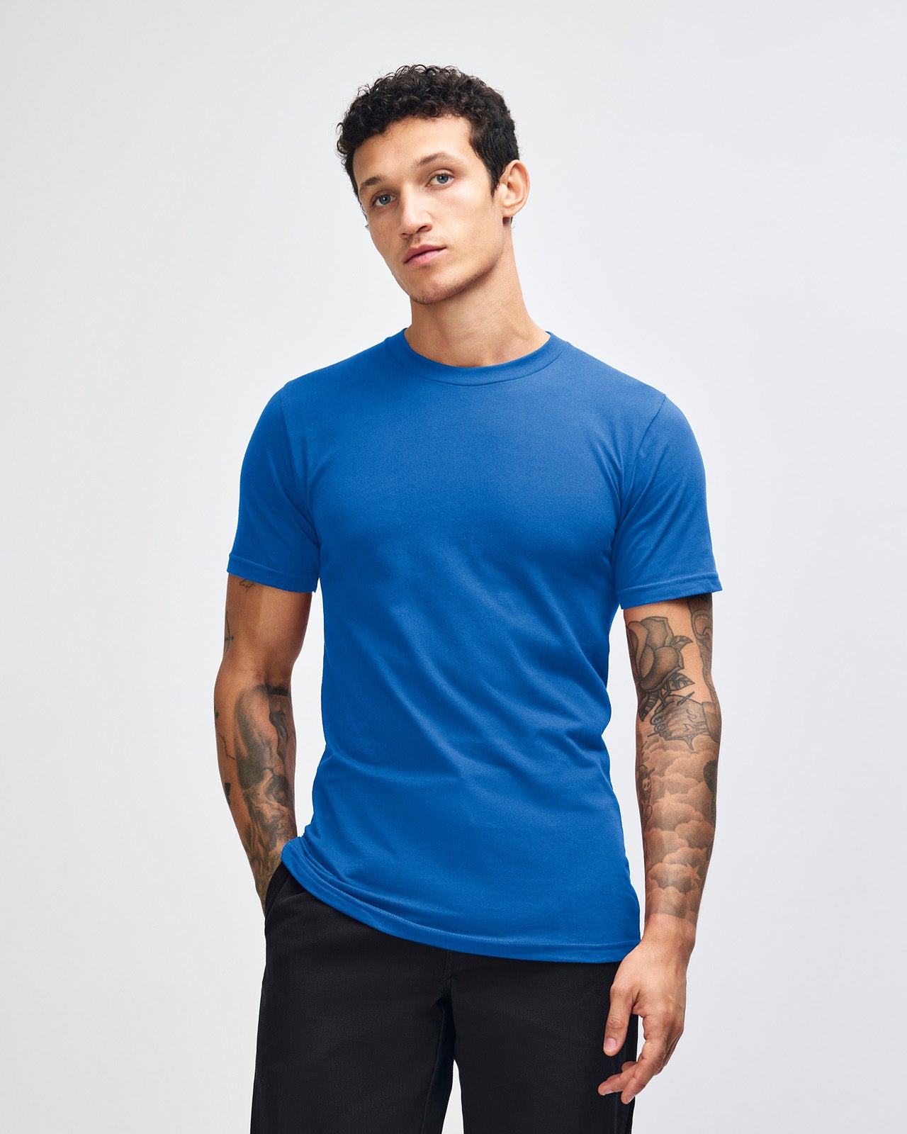 Male model wearing American Apparel Powder Royal Blue Colour Fine Jersey Unisex Short Sleeve Crew Neck Tee (front pose) -royal blue