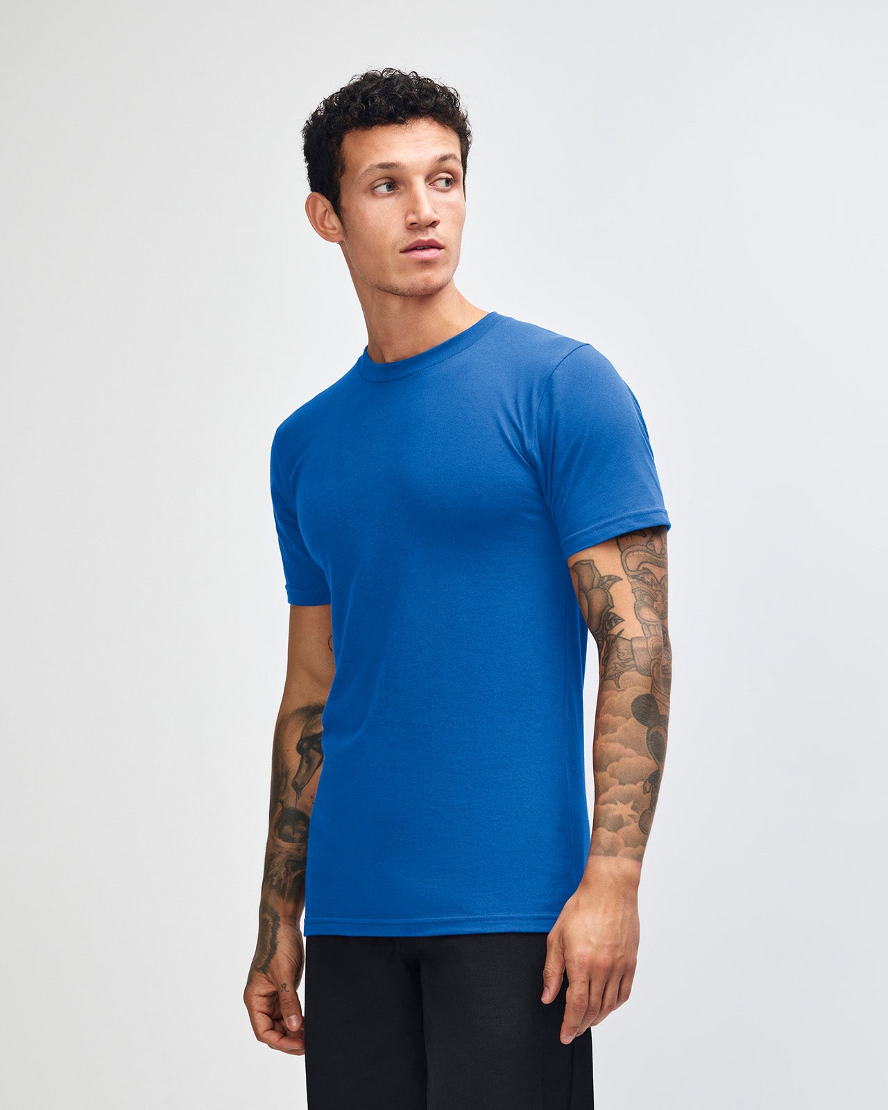 Male model wearing American Apparel Powder Royal Blue Colour Fine Jersey Unisex Short Sleeve Crew Neck Tee (front pose) -royal blue