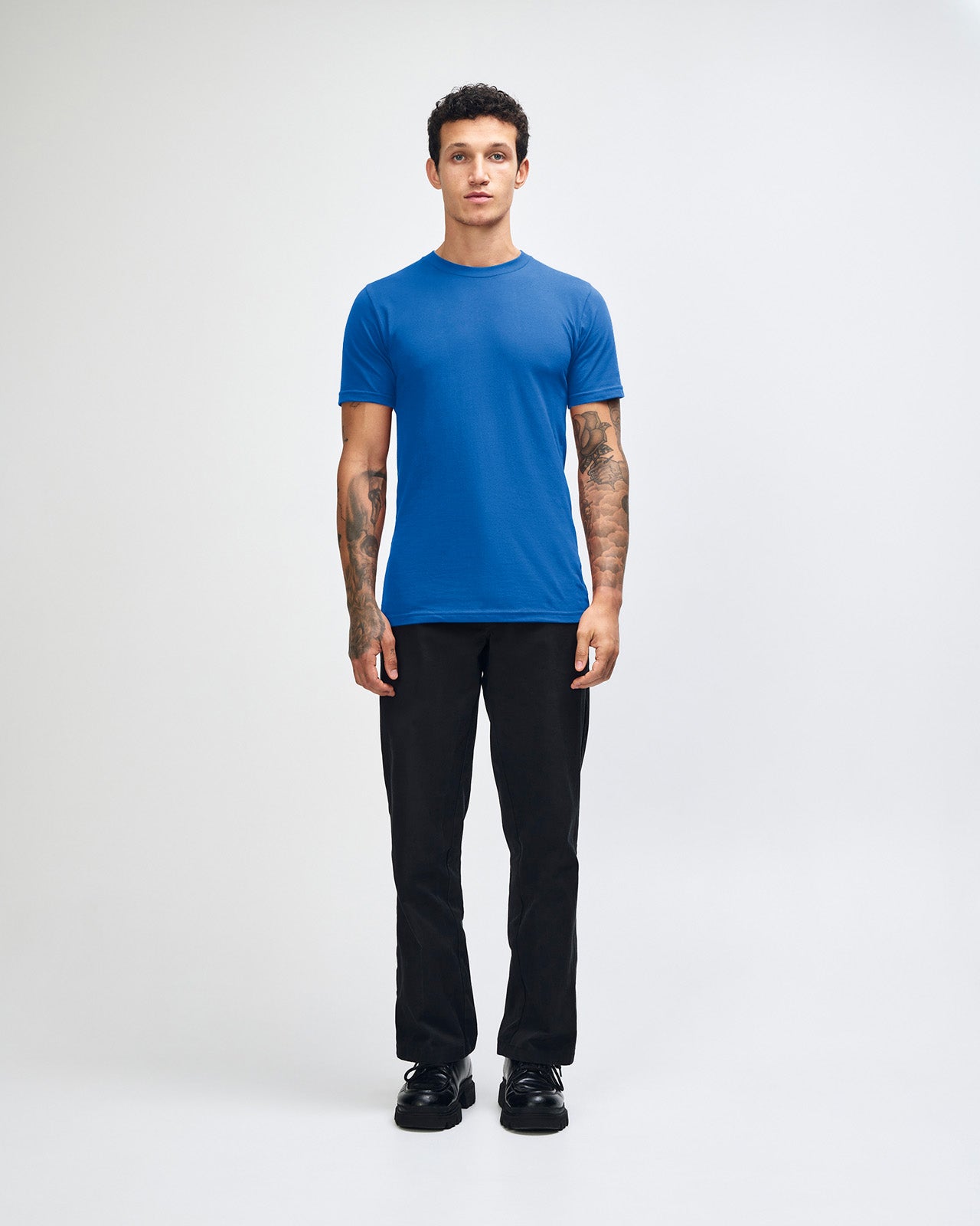Male model wearing American Apparel Powder Royal Blue Colour Fine Jersey Unisex Short Sleeve Crew Neck Tee (front pose) -royal blue