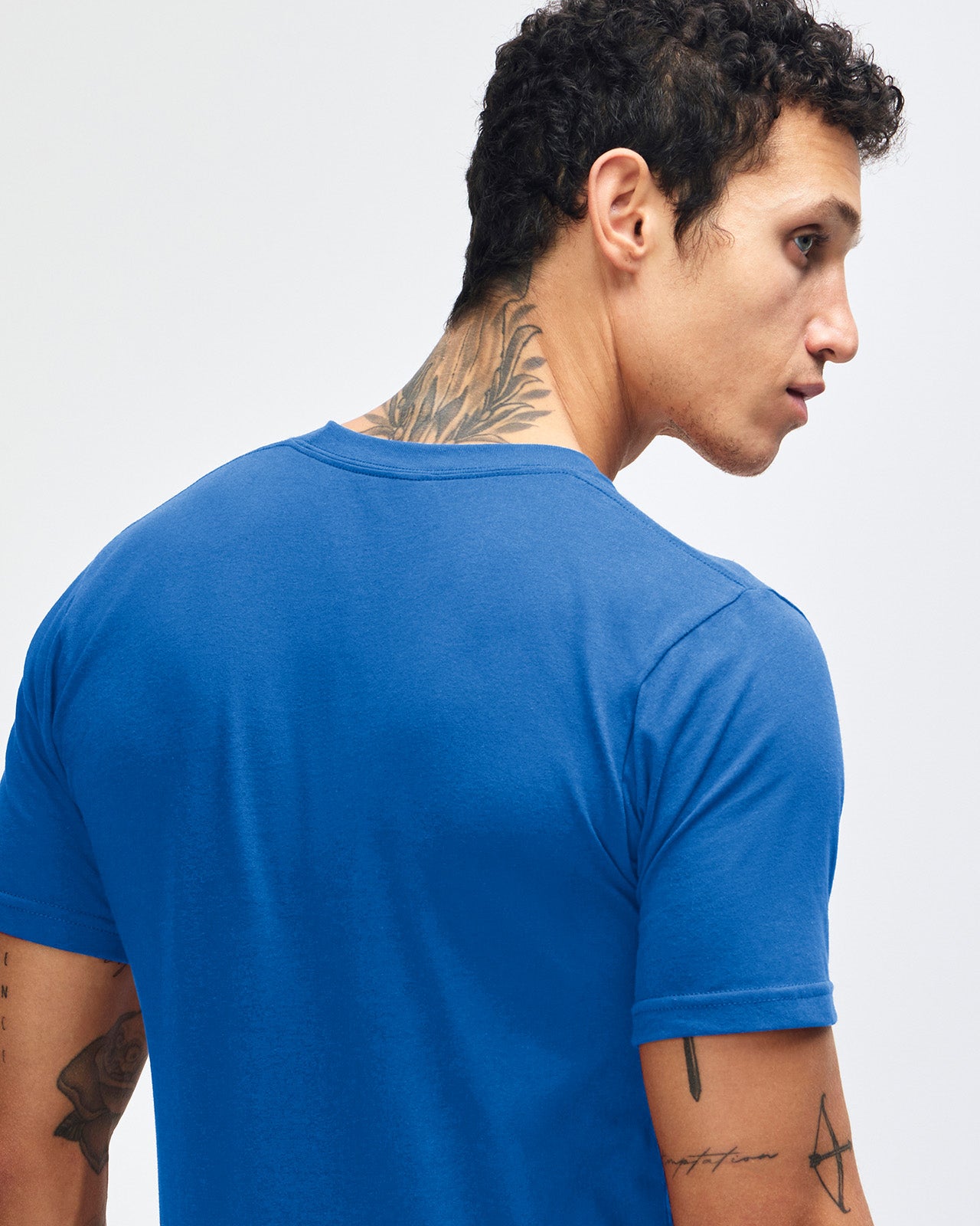 Male model wearing American Apparel Powder Royal Blue Colour Fine Jersey Unisex Short Sleeve Crew Neck Tee (back pose) -royal blue