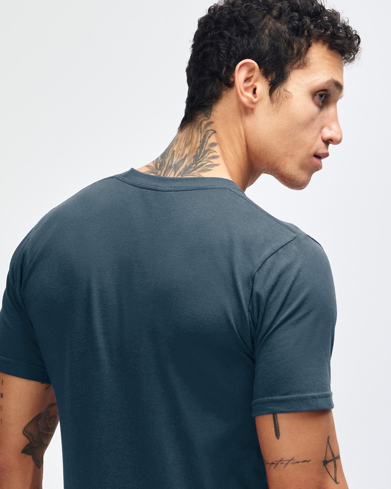 Male model wearing American Apparel Powder Sea Blue Colour Fine Jersey Unisex Short Sleeve Crew Neck Tee (back pose) -sea blue 