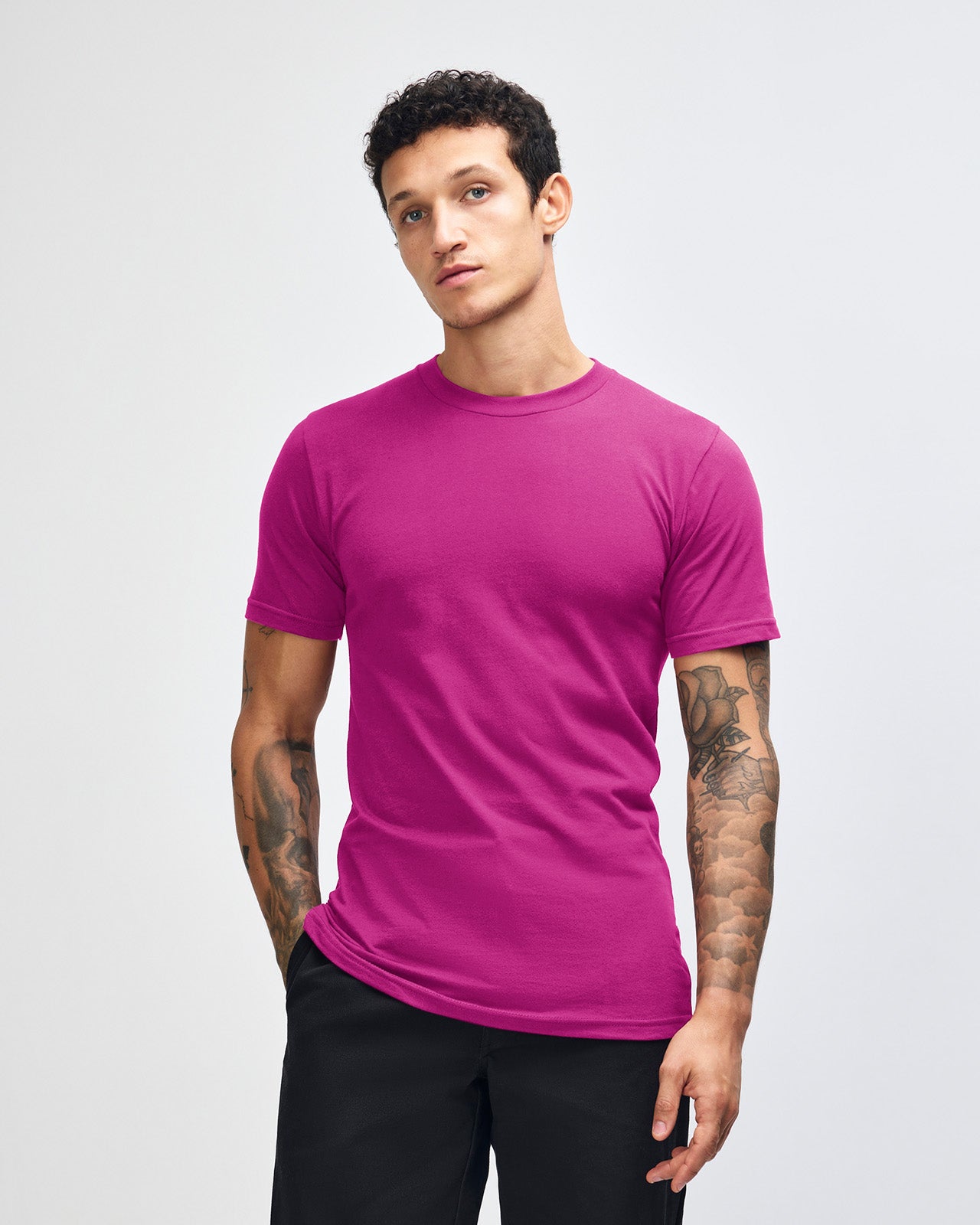 Male model wearing American Apparel Powder Super pink Colour Fine Jersey Unisex Short Sleeve Crew Neck Tee (front pose) -super pink 