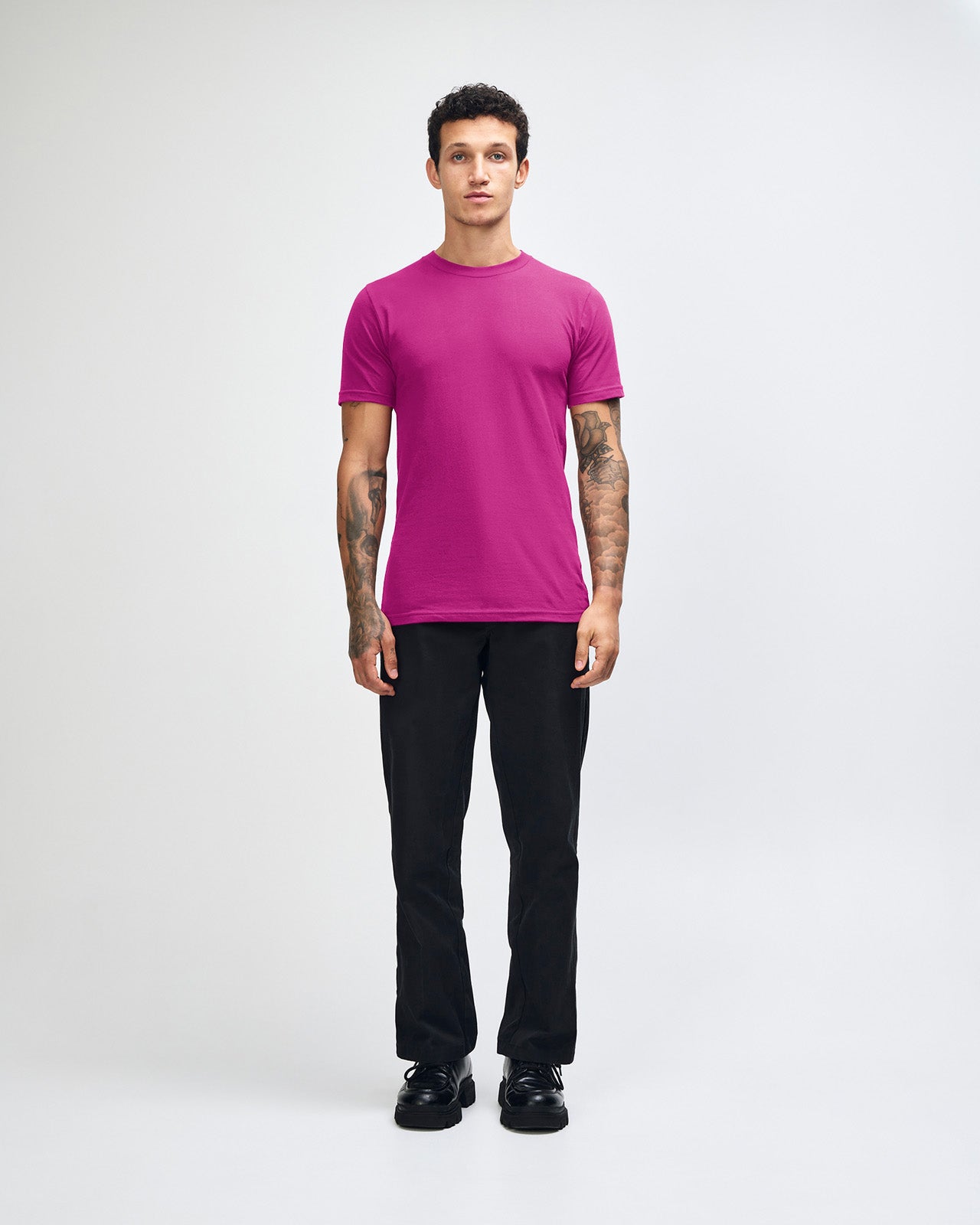 Male model wearing American Apparel Powder Super pink Colour Fine Jersey Unisex Short Sleeve Crew Neck Tee (front pose) -super pink 