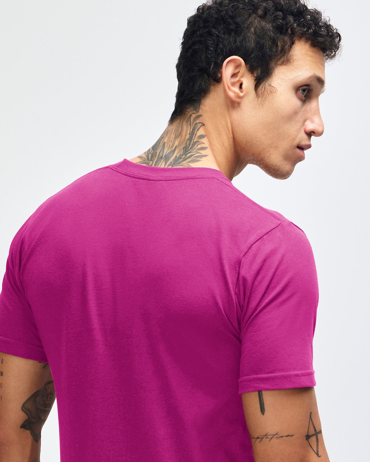 Male model wearing American Apparel Powder Super pink Colour Fine Jersey Unisex Short Sleeve Crew Neck Tee (back pose) -super pink 