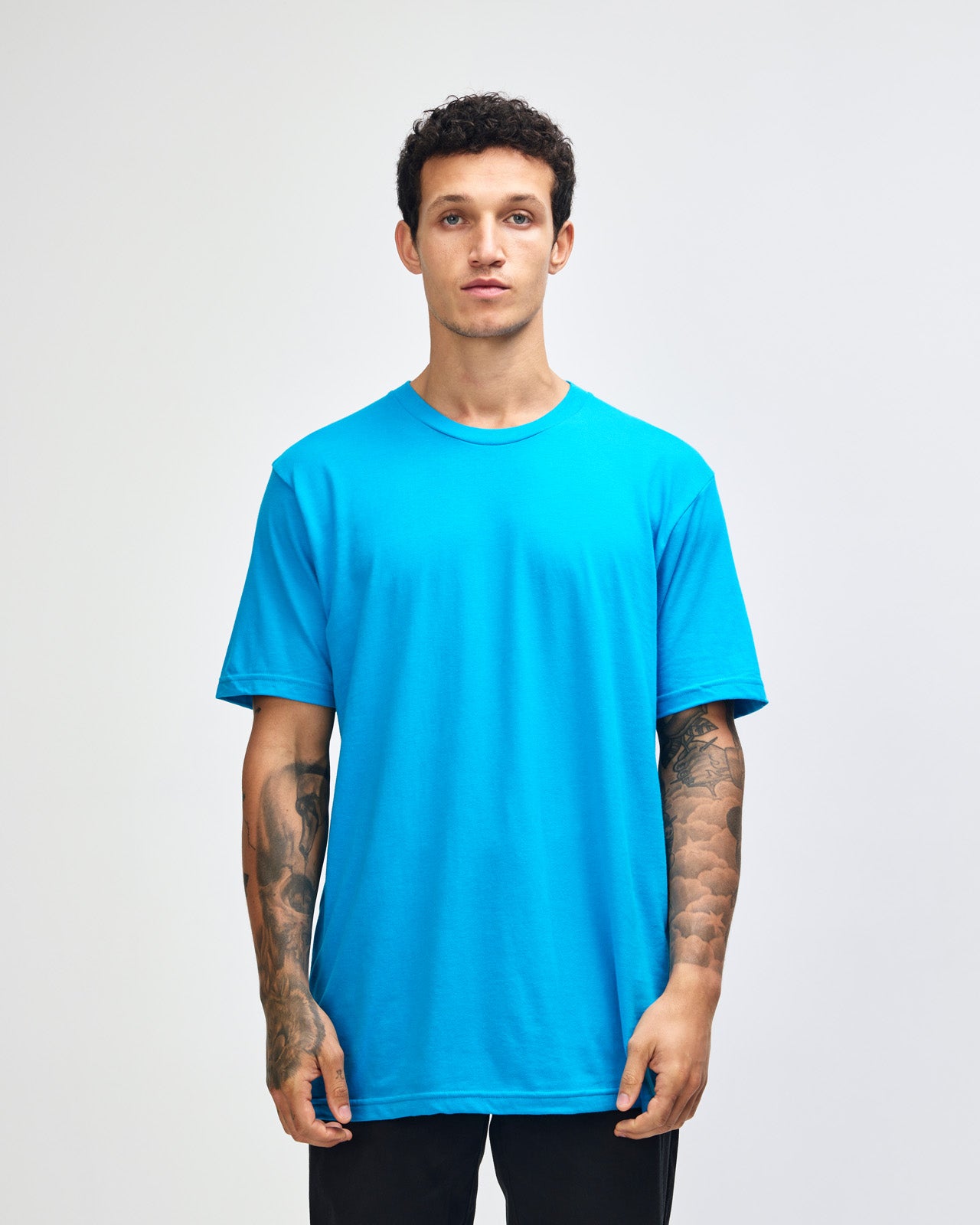 Male model wearing American Apparel Powder teal Colour Fine Jersey Unisex Short Sleeve Crew Neck Tee (front pose) -teal 
