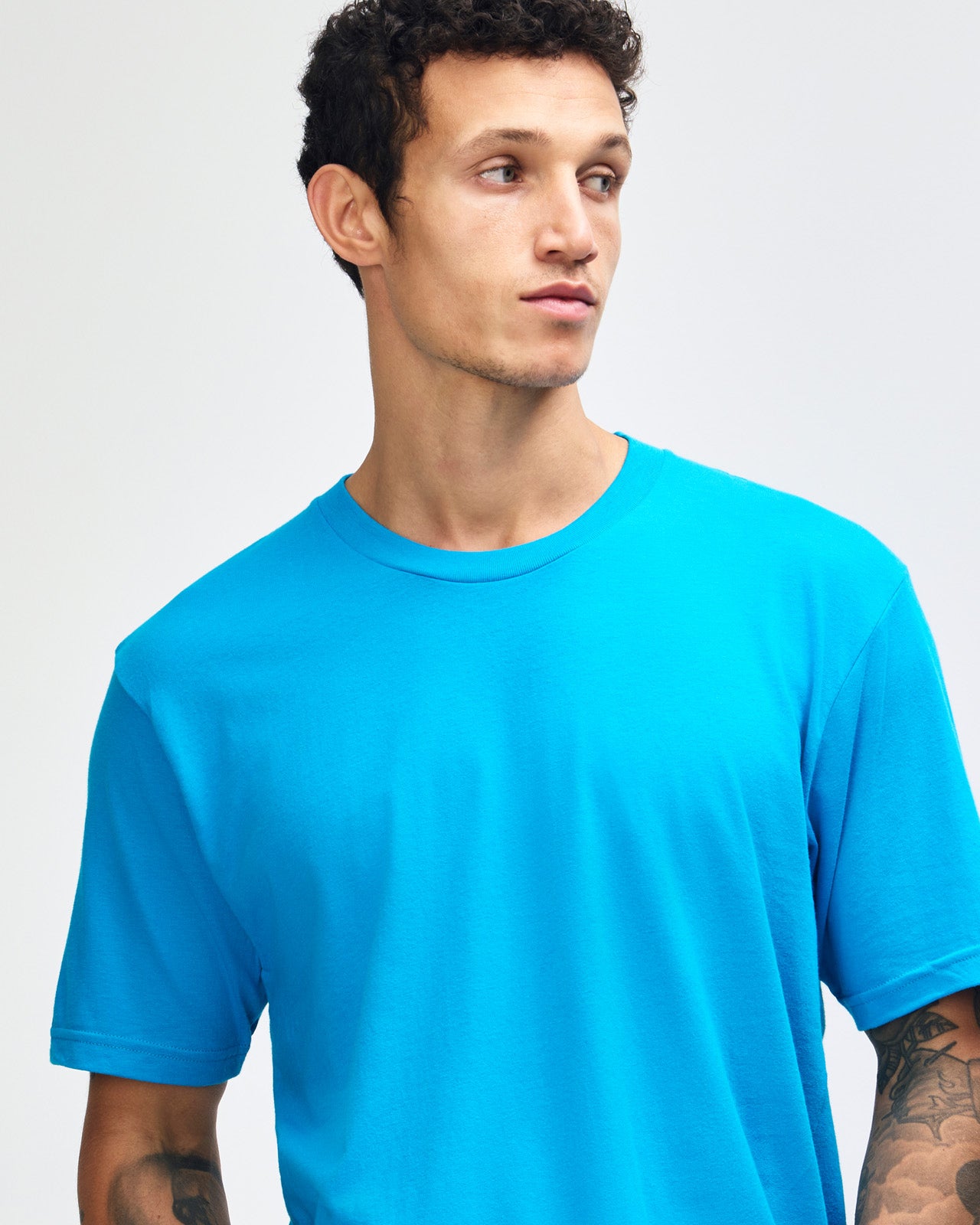 Male model wearing American Apparel Powder teal Colour Fine Jersey Unisex Short Sleeve Crew Neck Tee (front pose) -teal 