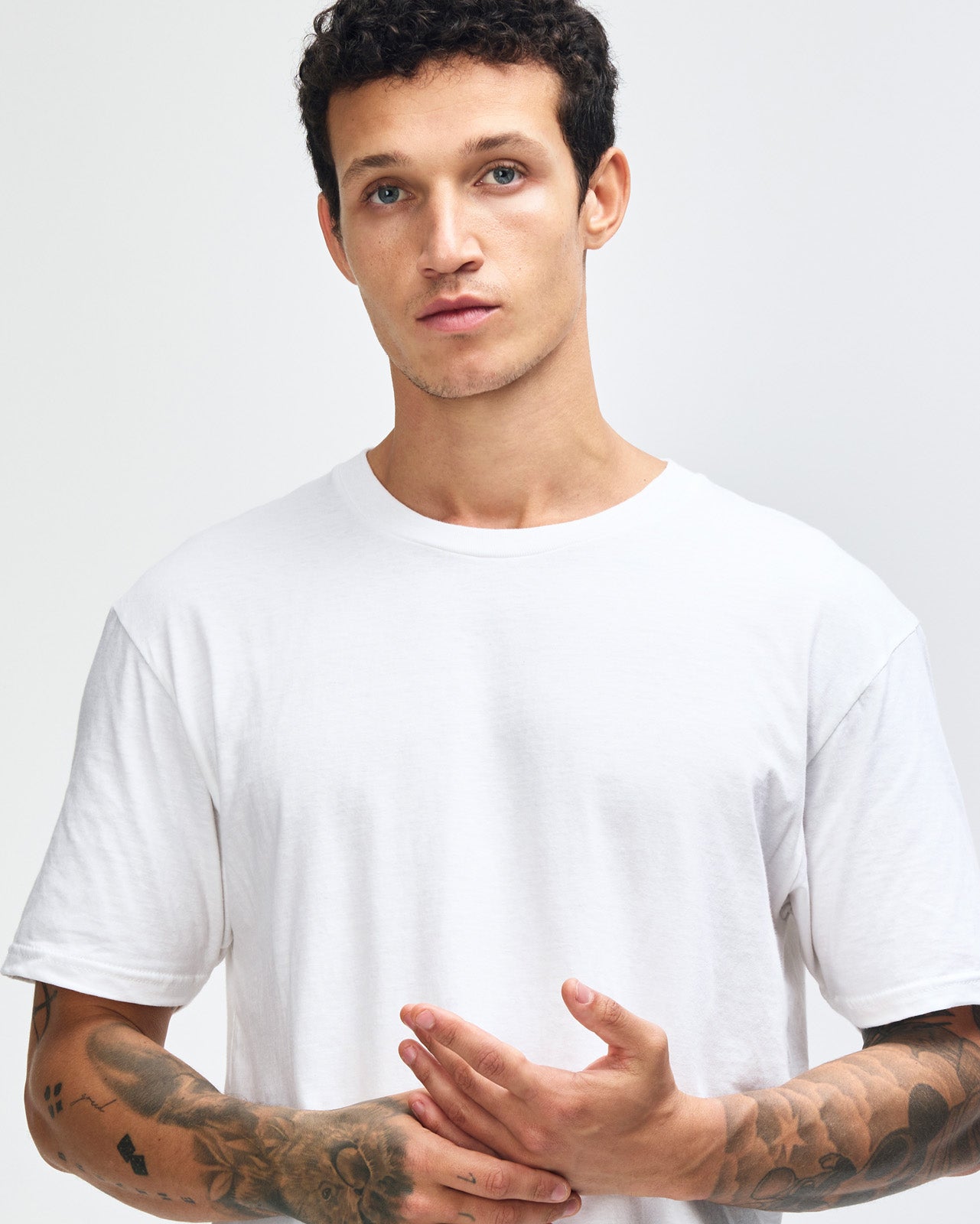 Male model wearing white colour CVC Unisex Short Sleeve Crew Neck Tee (front pose) -white