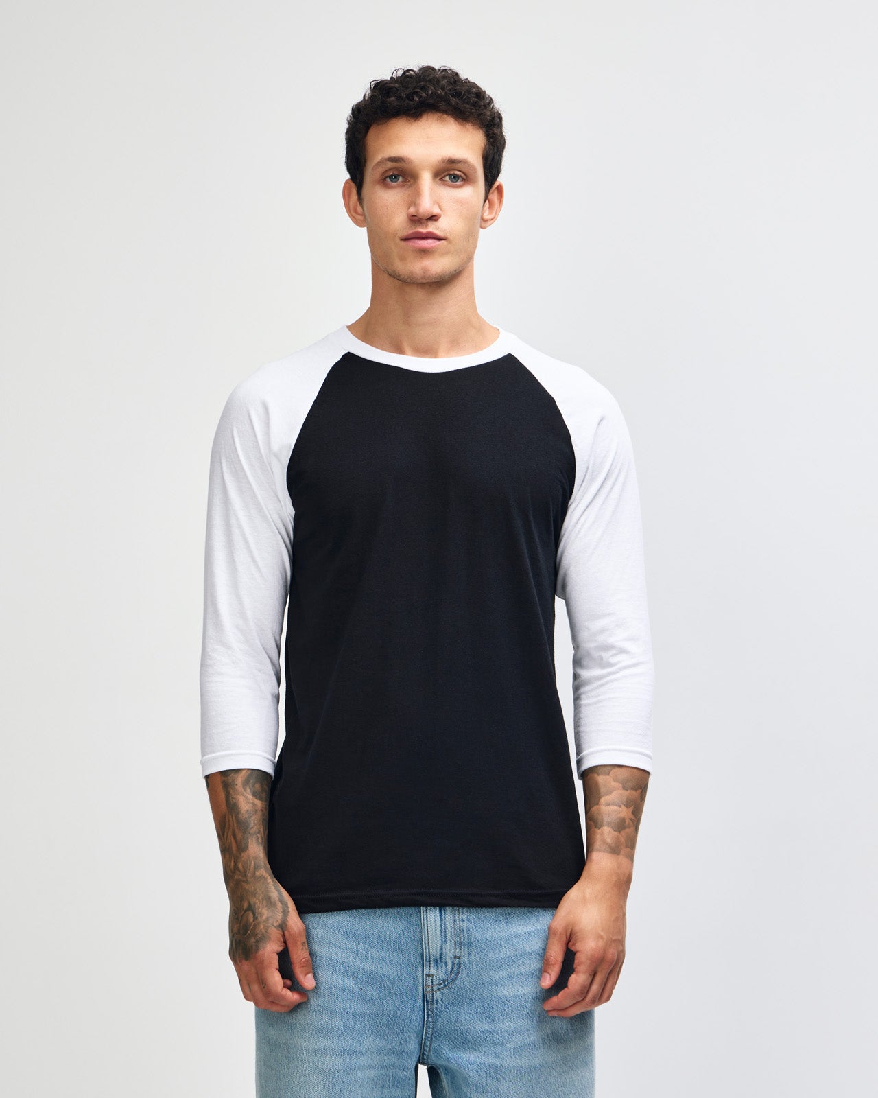 Male model wearing American Apparel CVC unisex raglan Tee (front pose) -black 