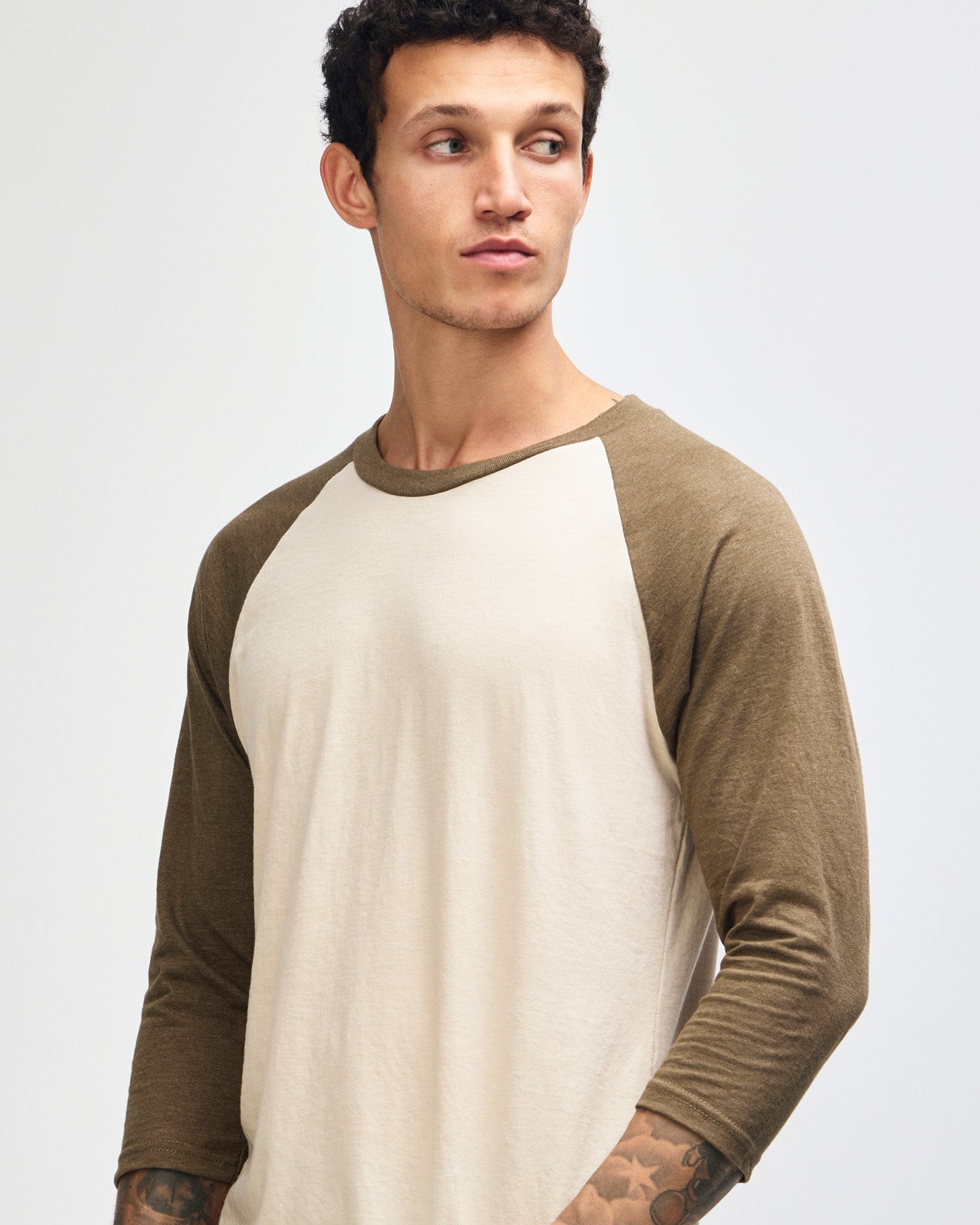 Male model wearing Heather Bone American Apparel CVC unisex raglan Tee (Front  pose) -heather bone