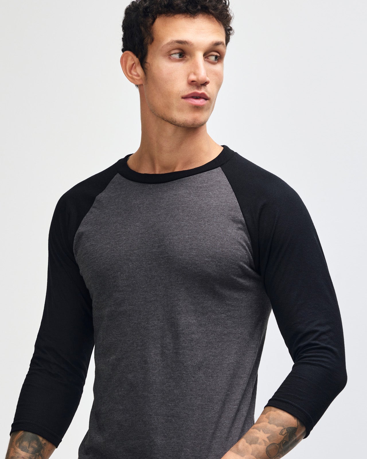 Male model wearing Heather Charcoal American Apparel CVC unisex raglan Tee (Front  pose) -heather charcoal