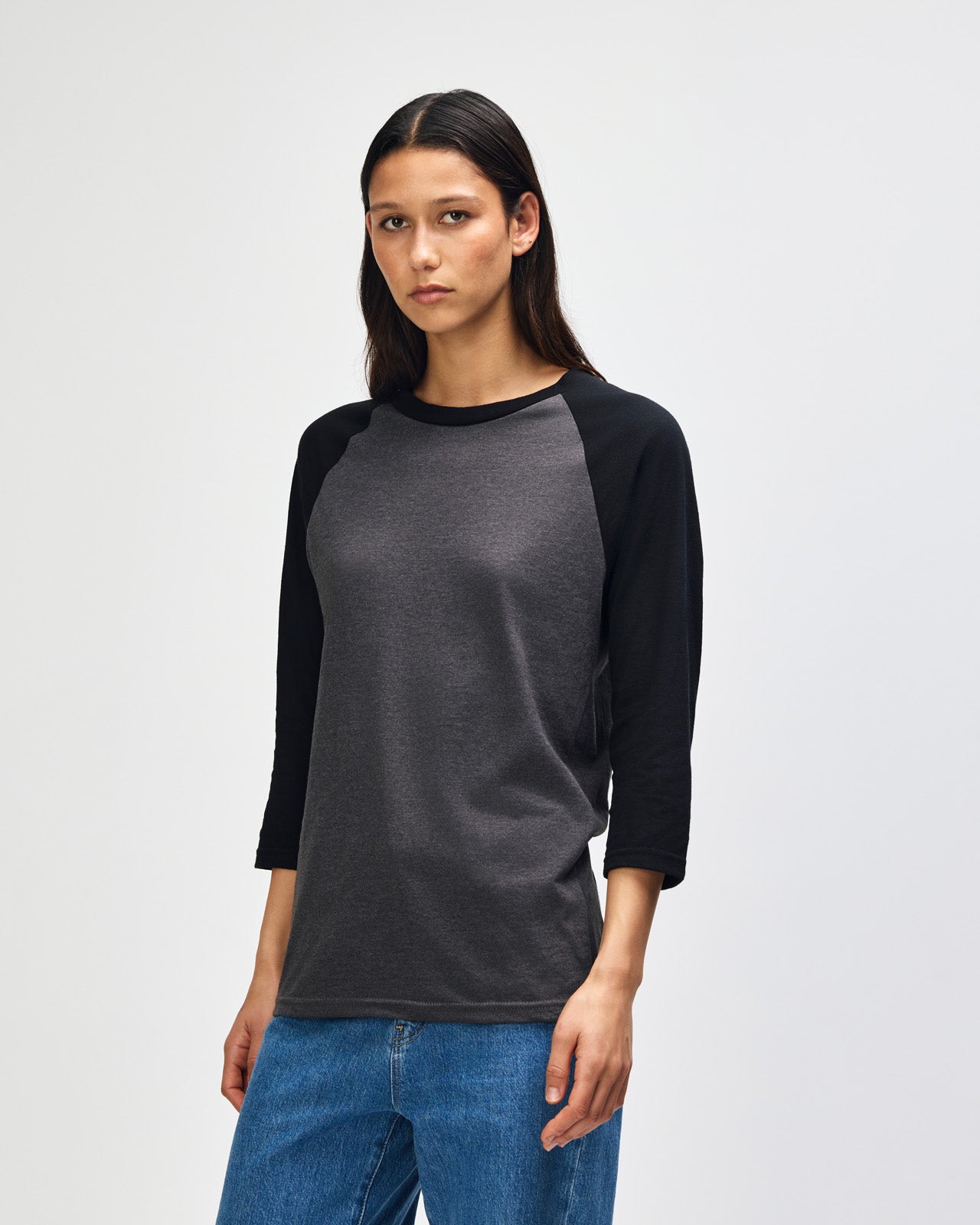 Female model wearing Heather Charcoal American Apparel CVC unisex raglan Tee (Front  pose) -heather charcoal