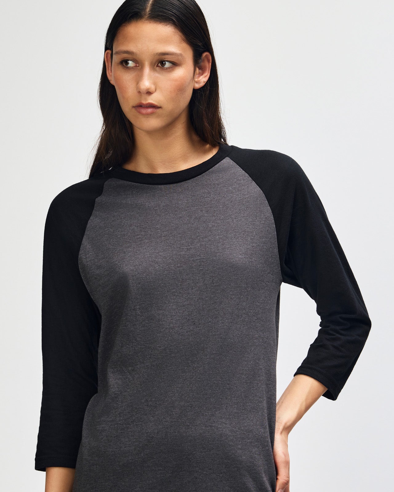 Female model wearing Heather Charcoal American Apparel CVC unisex raglan Tee (Front  pose) -heather charcoal