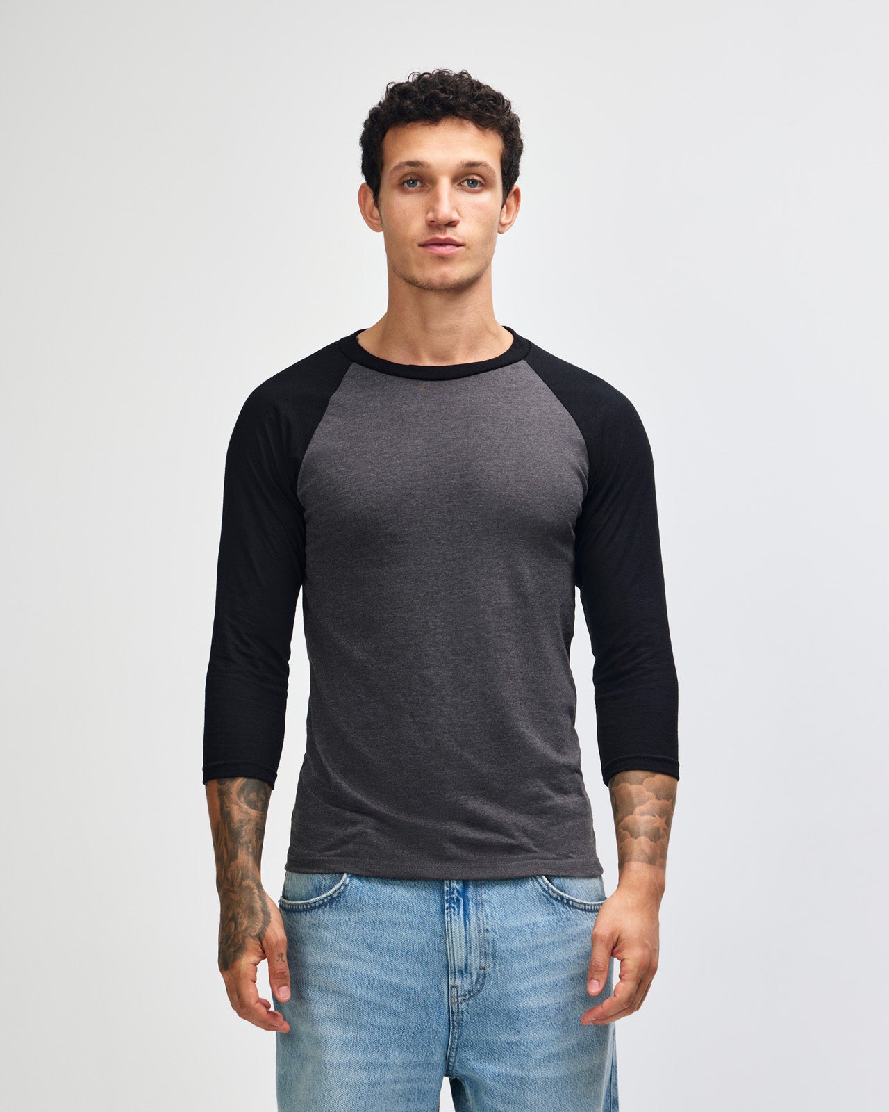 Male model wearing Heather Charcoal American Apparel CVC unisex raglan Tee (Front  pose) -heather charcoal