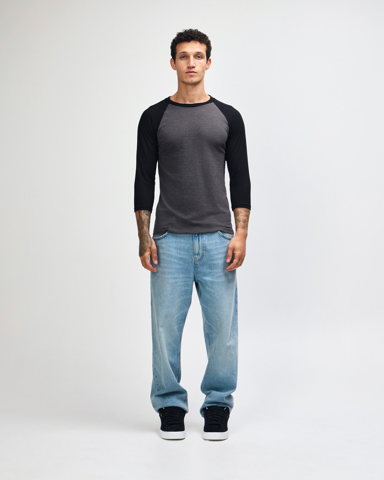 Male model wearing Heather Charcoal American Apparel CVC unisex raglan Tee (Front  pose) -heather charcoal